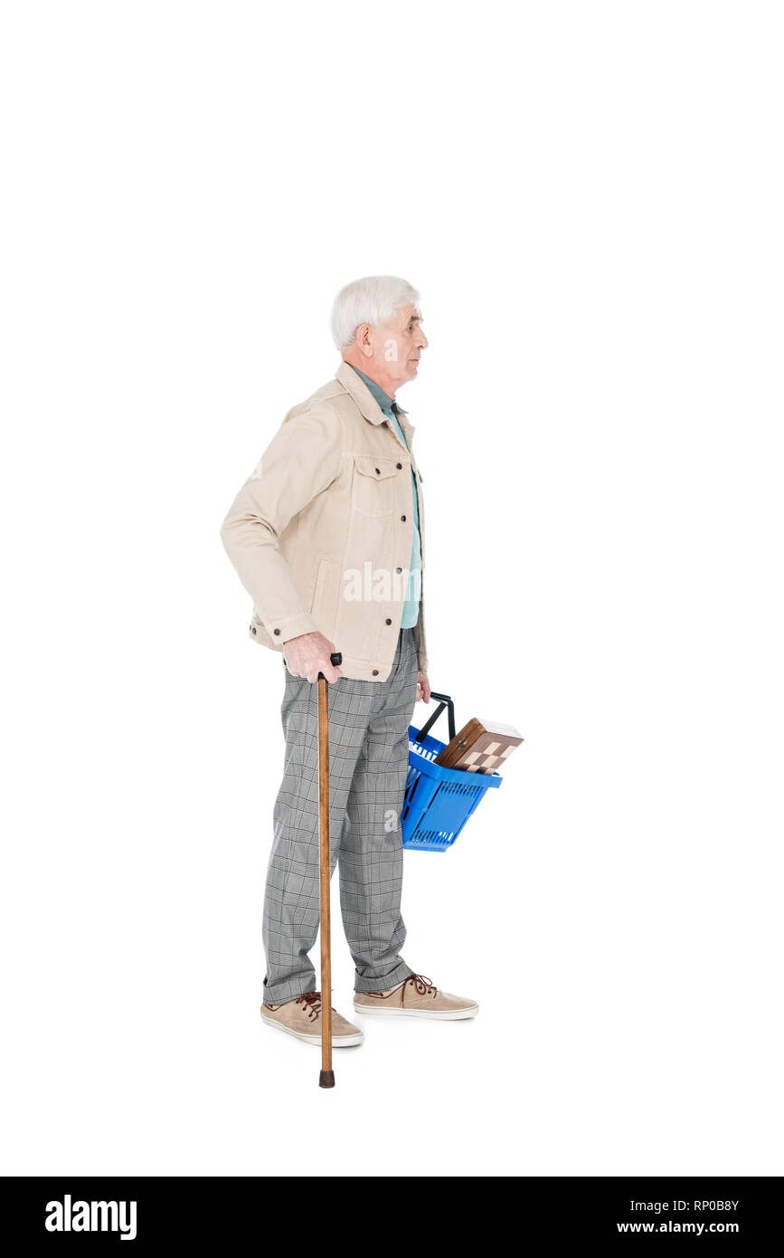 retired man holding shopping basket and standing with walking cane