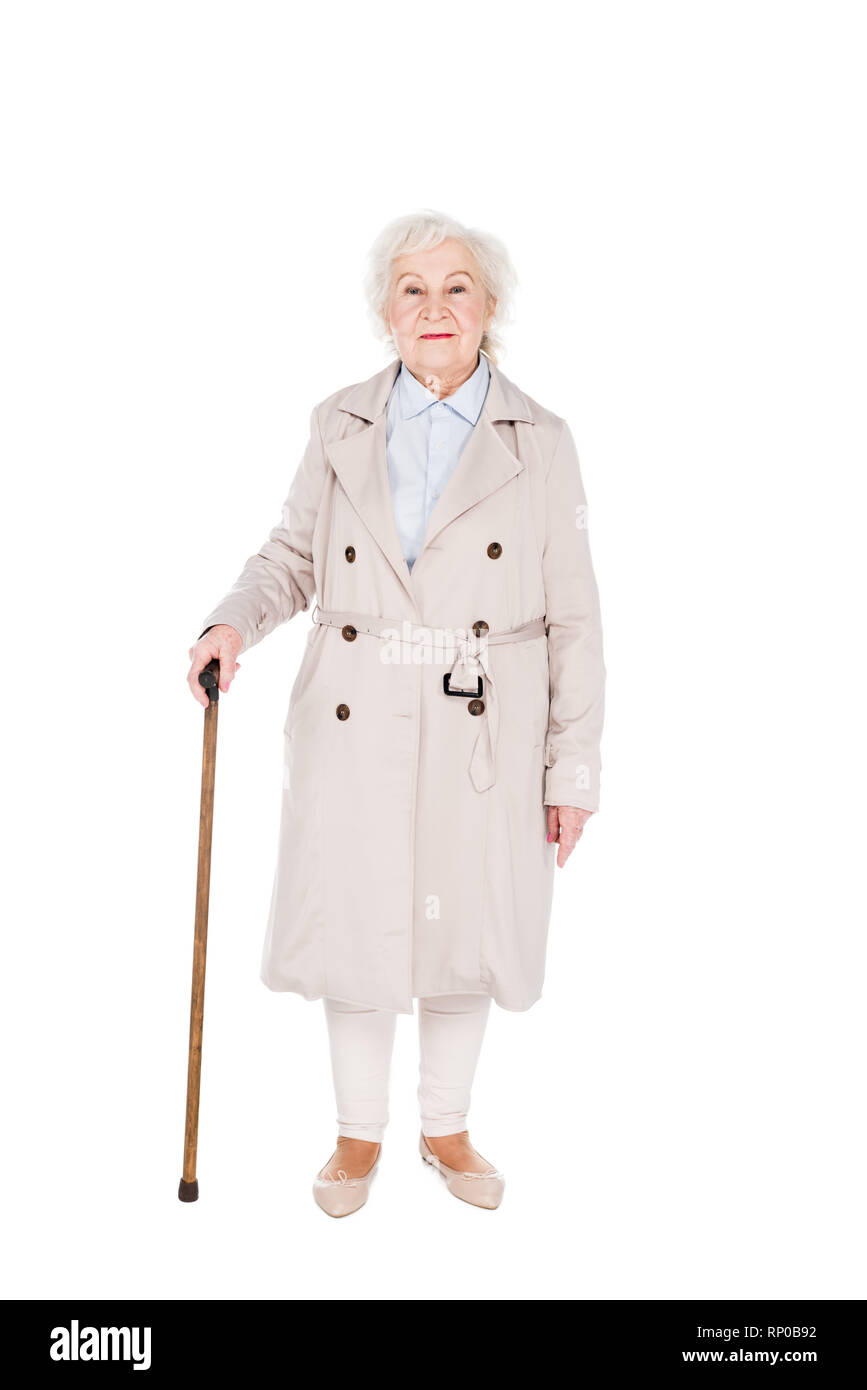 cheerful senior woman standing with walking cane isolated on white Stock Photo