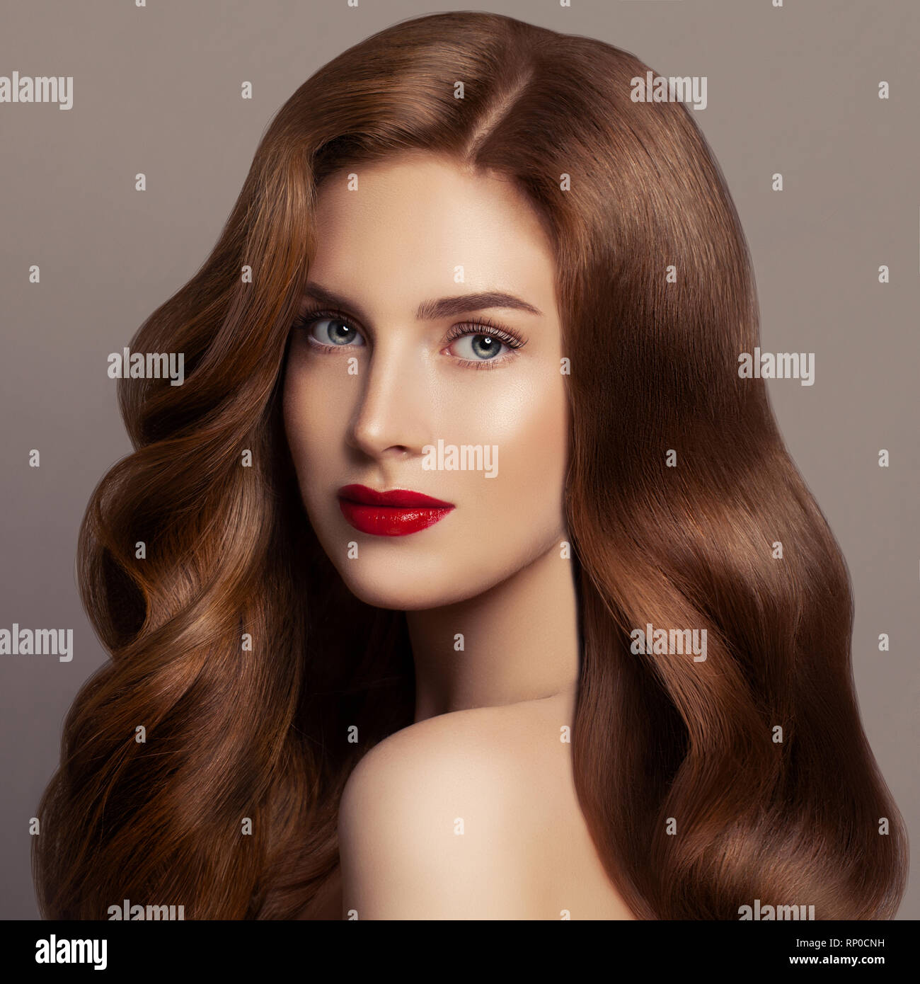 Beautiful hair woman. Female model girl with long red curly hair. Redhead woman portrait Stock Photo
