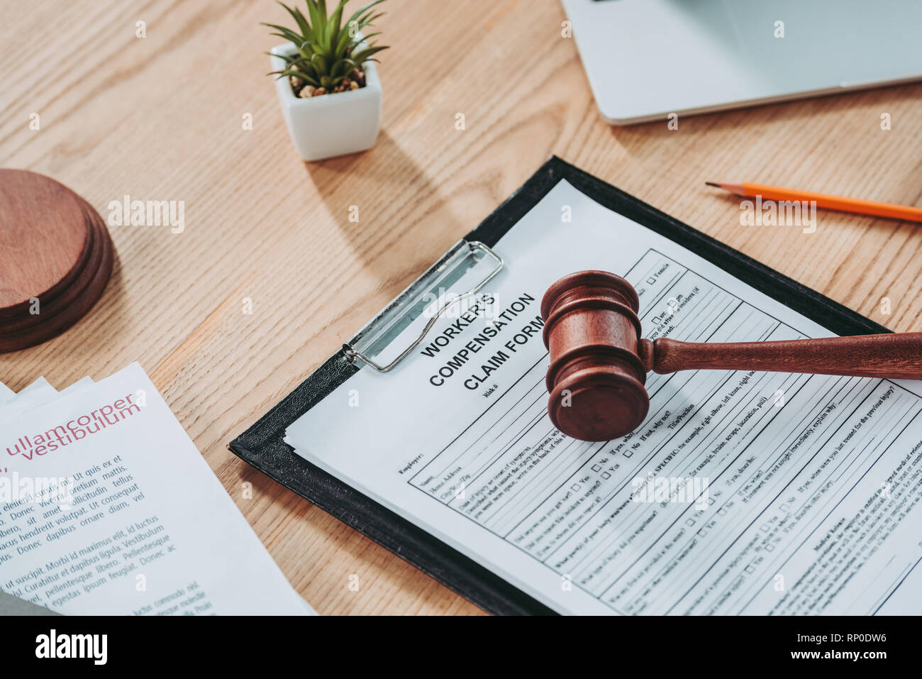 clipboard with compensation claim form and gavel on office desk Stock
