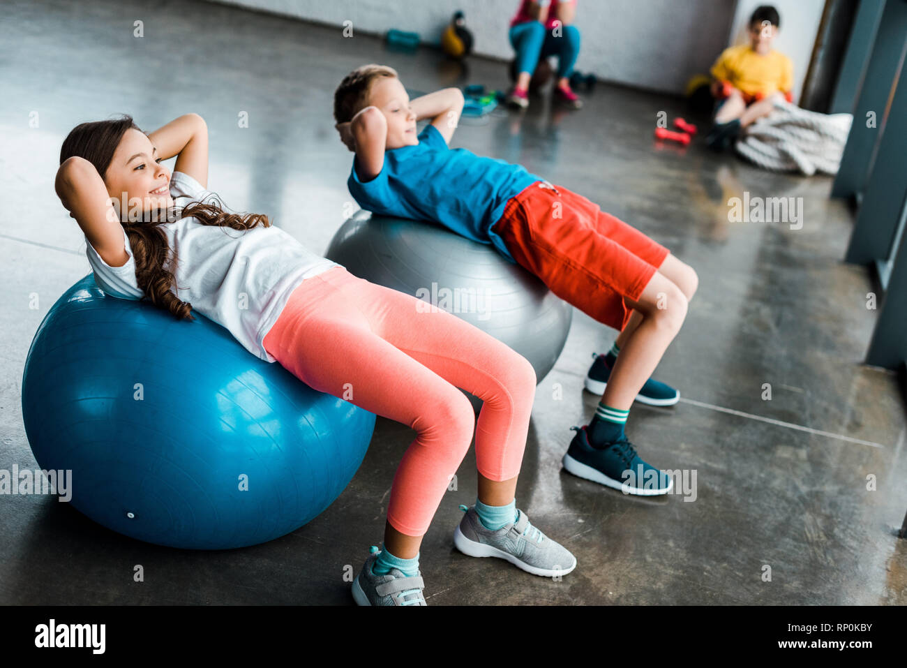 Kids doing abs exercise with fitness balls Stock Photo - Alamy