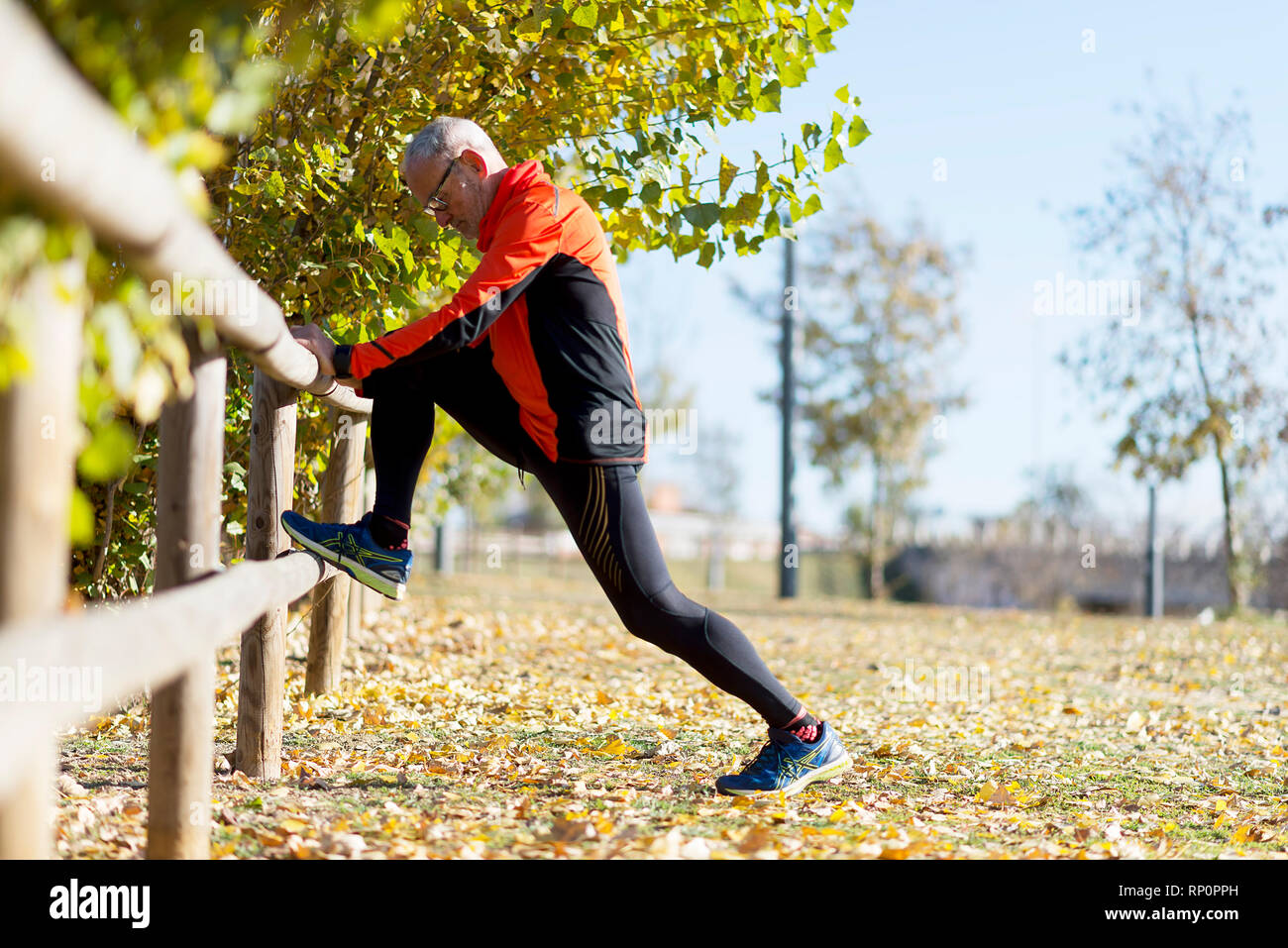 Senior Man Exercising In Park Stock Photo