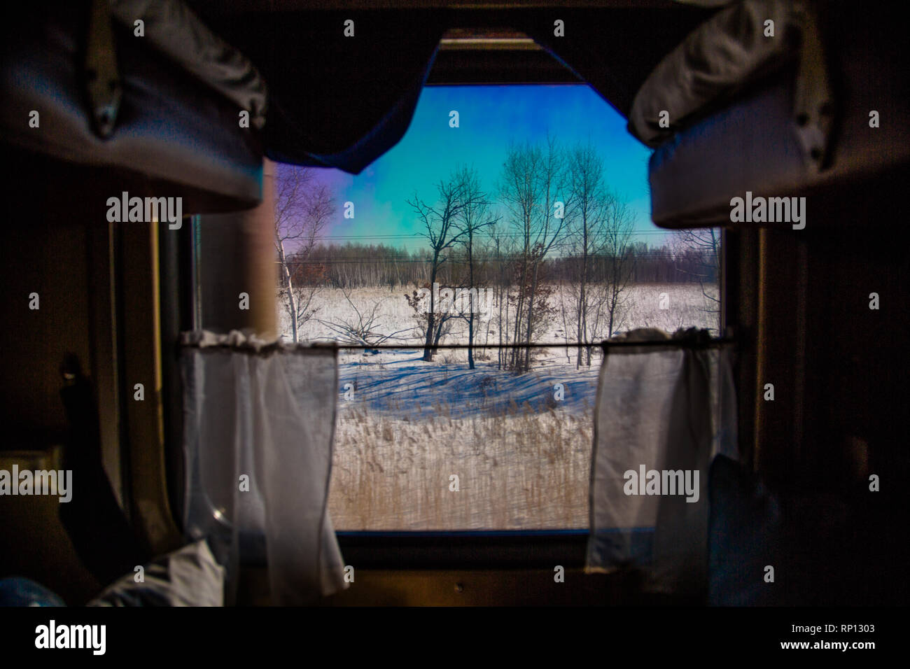 A frozen tundra presents itself from the view out of the window of a  sleeper cabin on the Trans-Siberian train, Russia Stock Photo