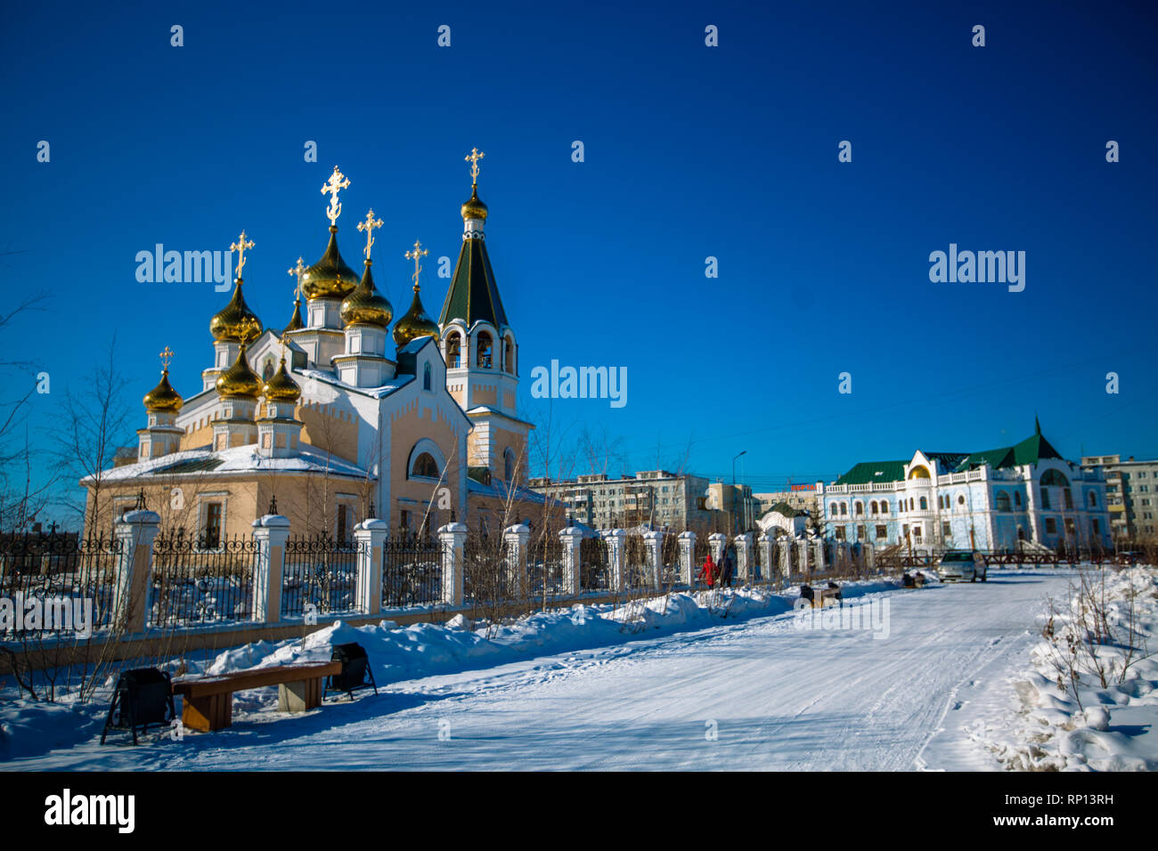 The crosses and onion domes of Russian Orthodox Church set against a blue sky. Stock Photo