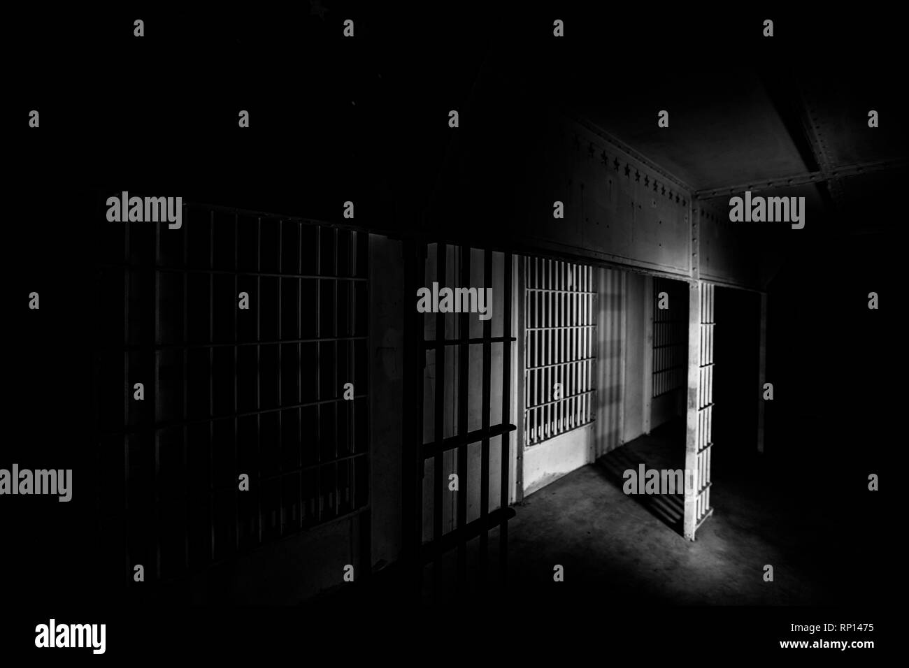 A light splashes along the floor and bars of an abandoned prison. USA Stock Photo