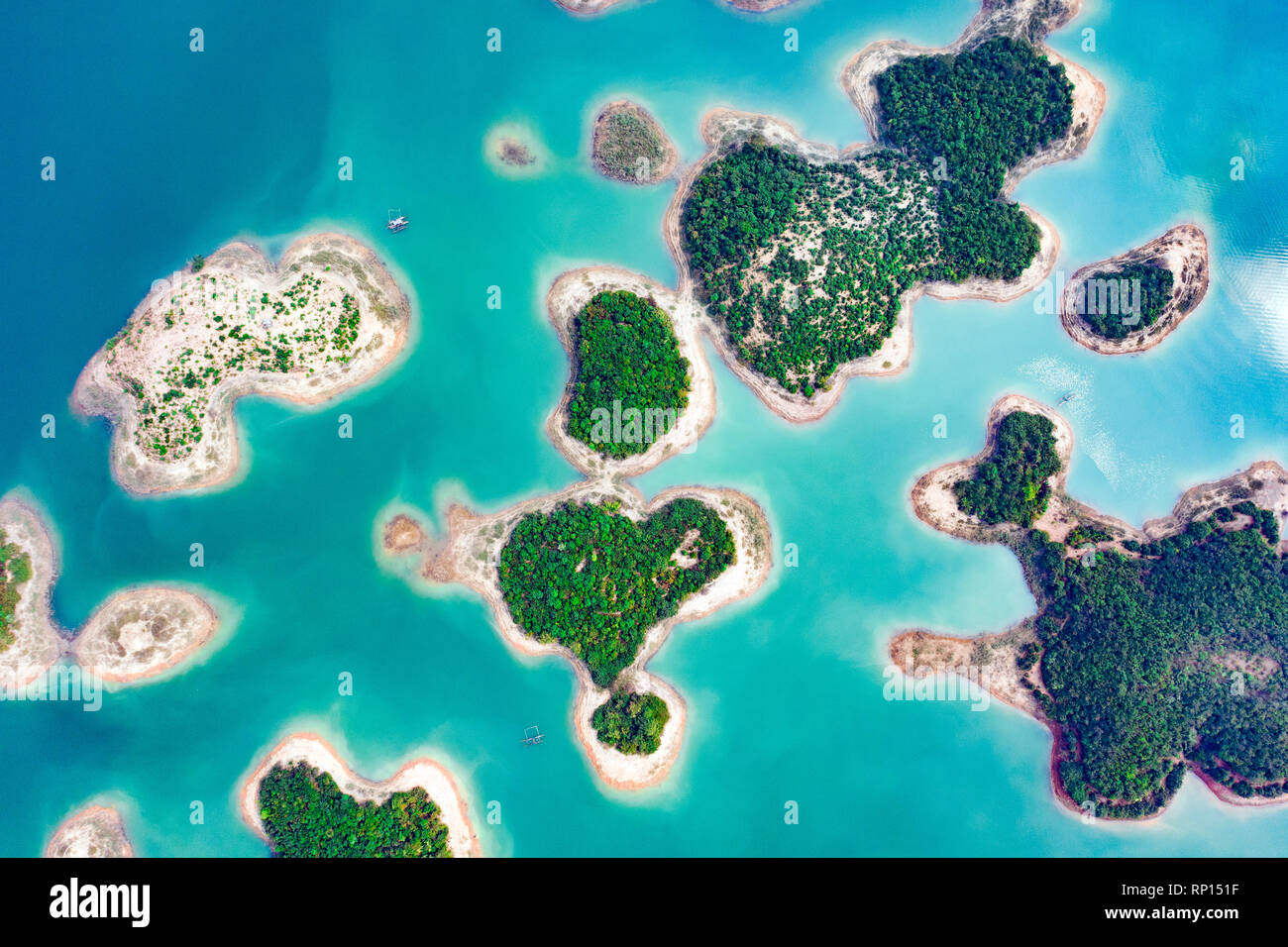(View from above) Stunning aerial view of a heart-shaped island in the middle of a group of other islands in Nam Ngum Reservoir in Thalat. Stock Photo