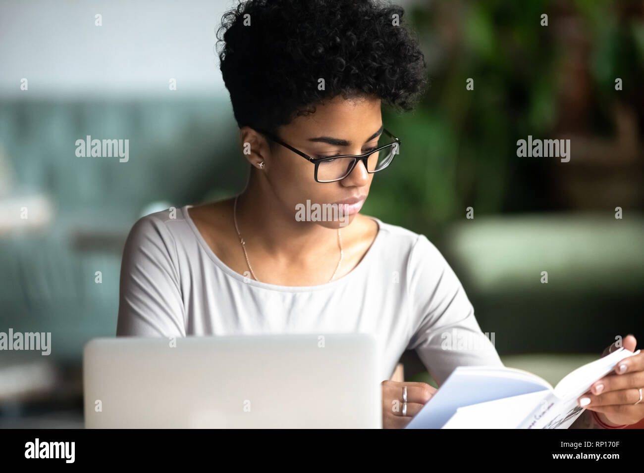 Concentrated african beautiful woman studying reading a book Stock Photo