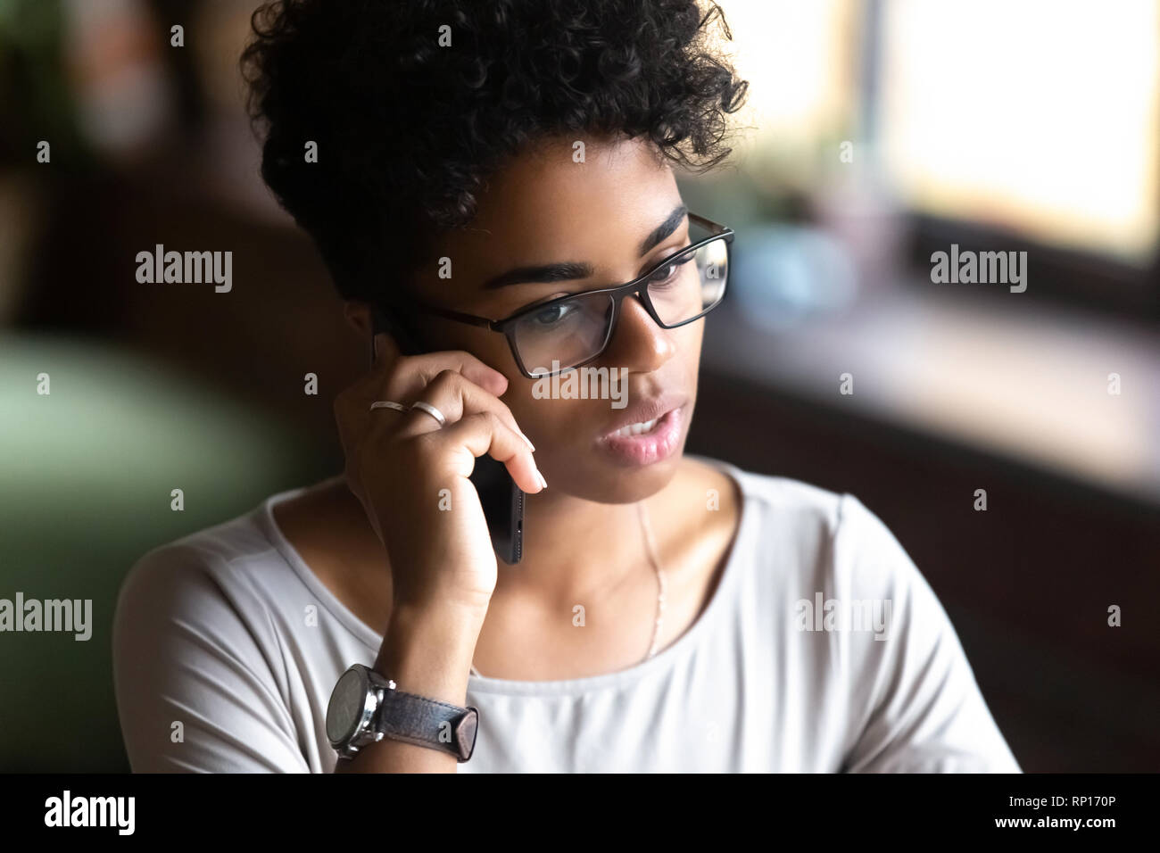 Close up portrait attractive serious young woman talking on phone Stock Photo