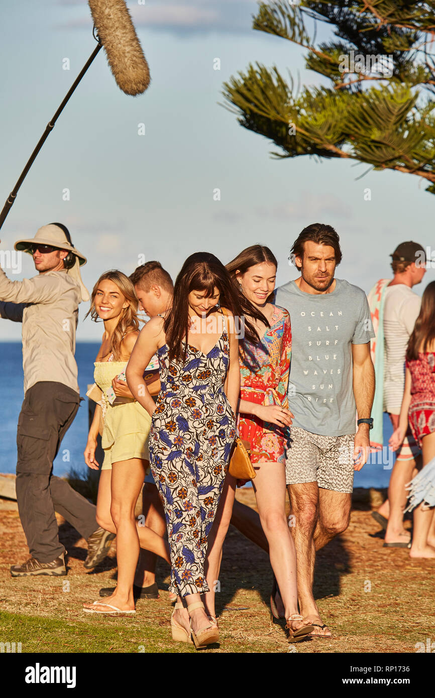 Actors and a sound boom operator filming an outdoor scene of Home And Away television programme at Palm Beach, New South Wales, Australia Stock Photo