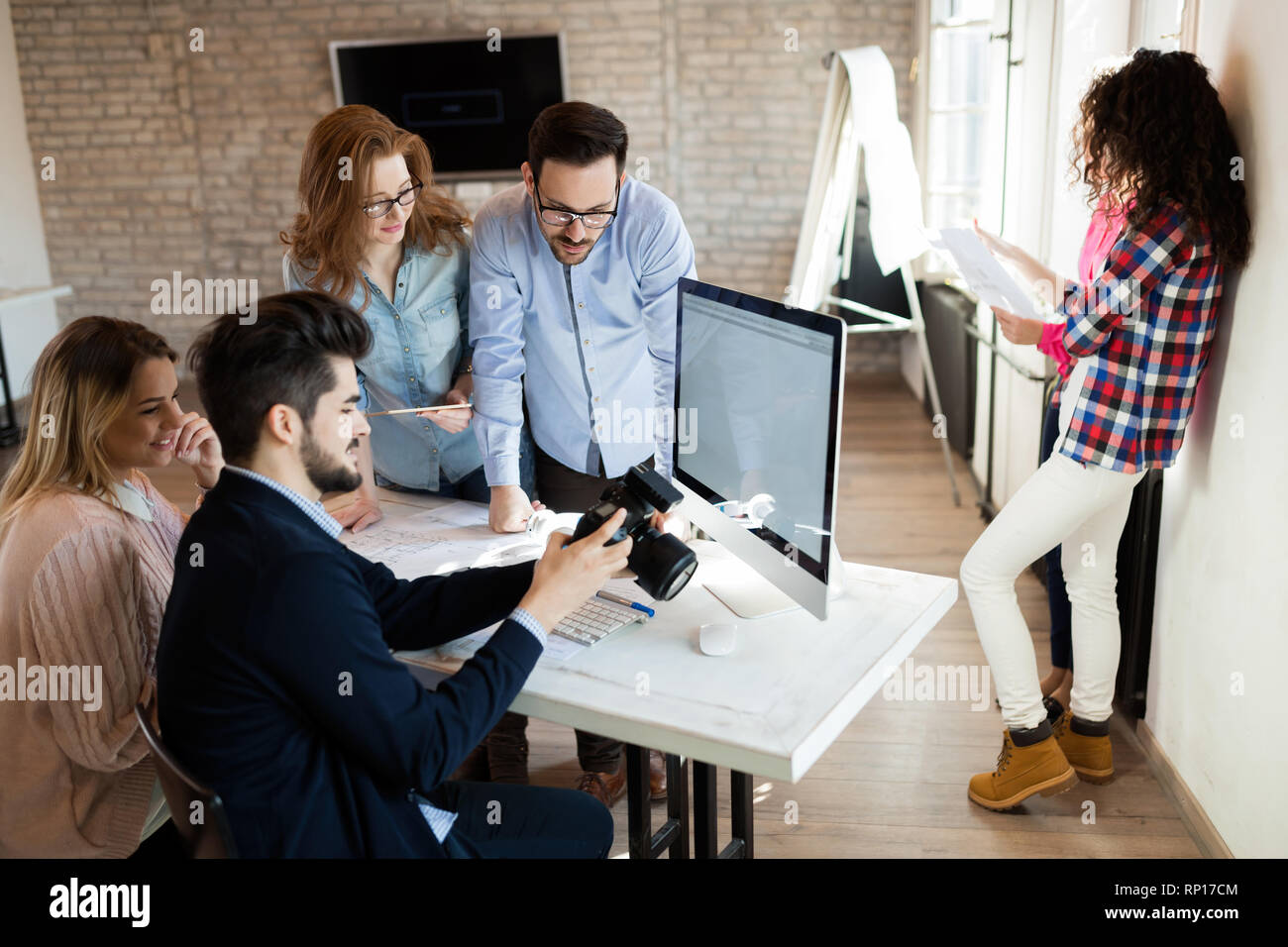 Picture of young attractive designers looking at camera Stock Photo