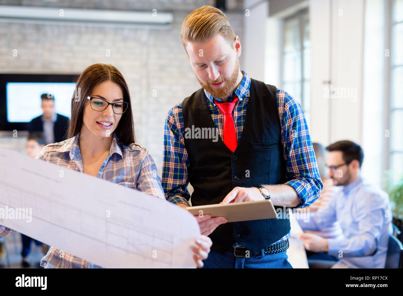 Business people and architects collaborating on project Stock Photo