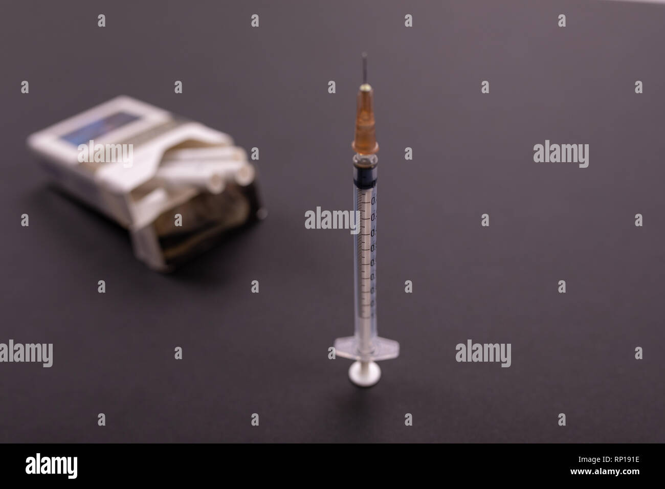 syringes stick out of a pack of cigarettes Stock Photo Alamy