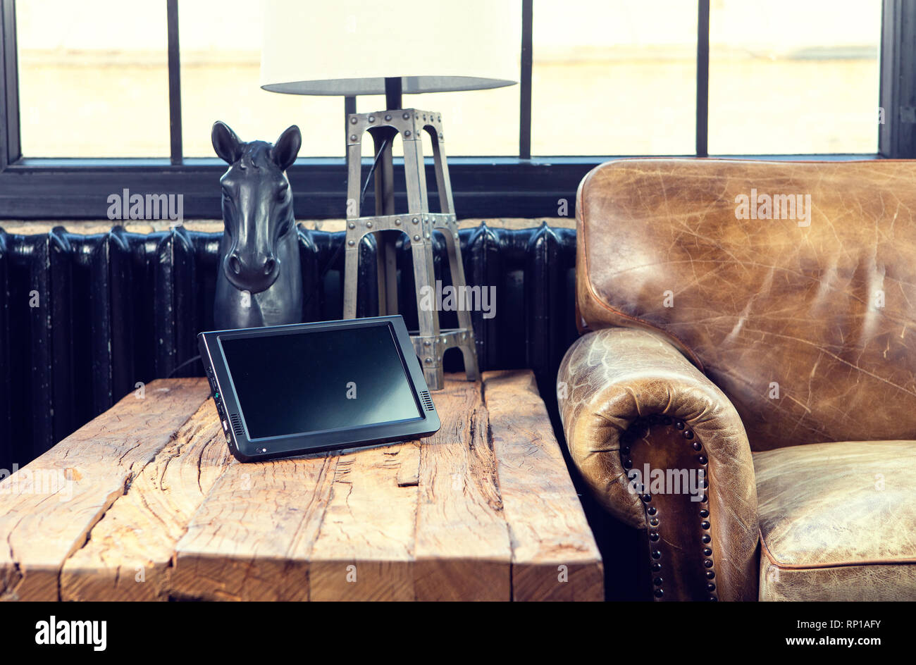 Mini TV on a wooden table in vintage interior with loft style Stock Photo