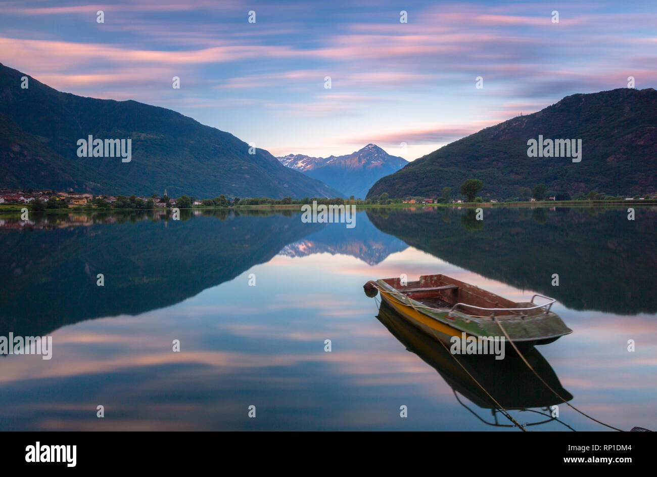 Boat moored in lake of Novate Mezzola at sunrise, Valchiavenna, Sondrio province, Valtellina, Lombardy, Italy Stock Photo