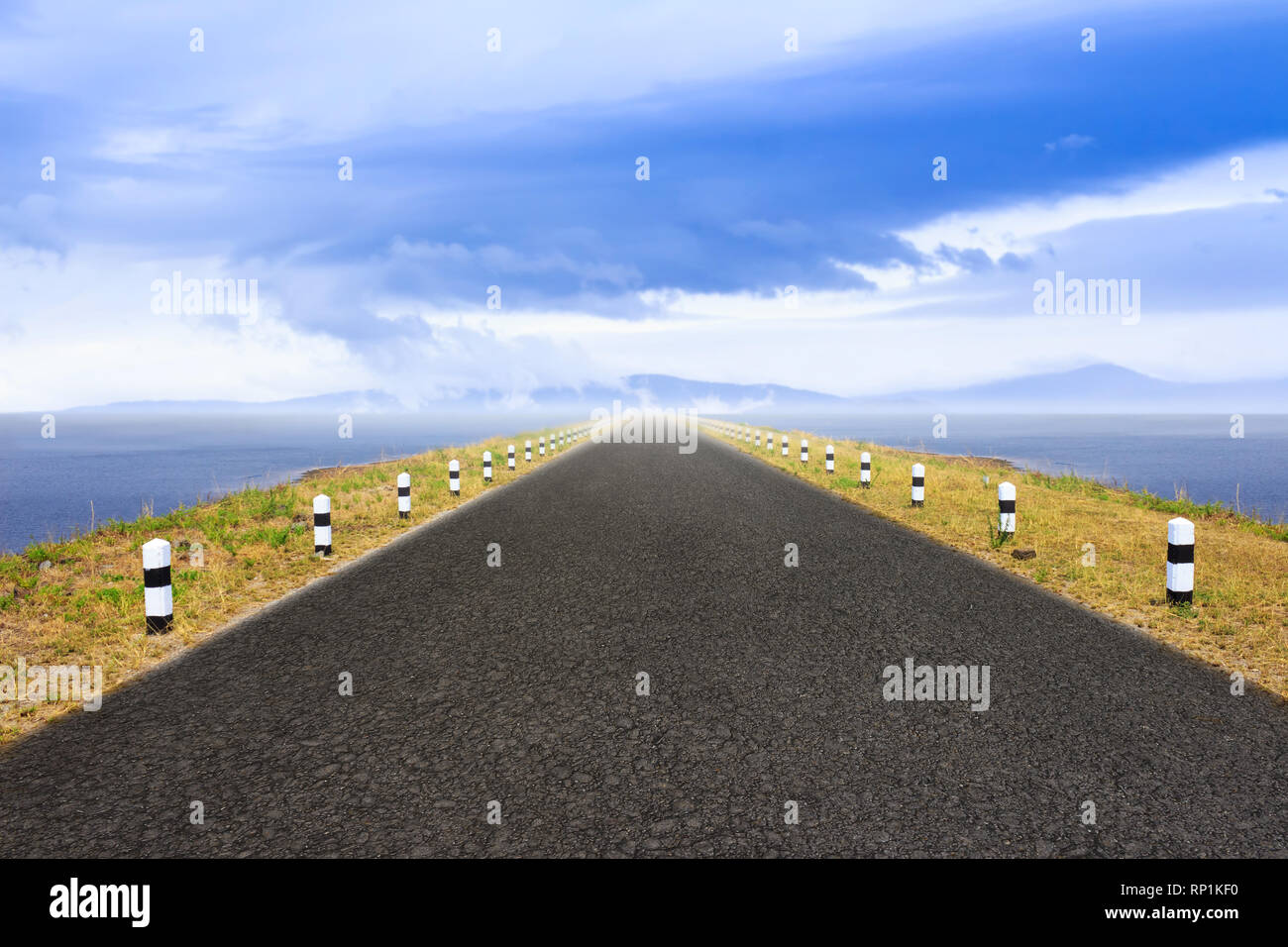 Road over a dike along a lake Stock Photo Alamy
