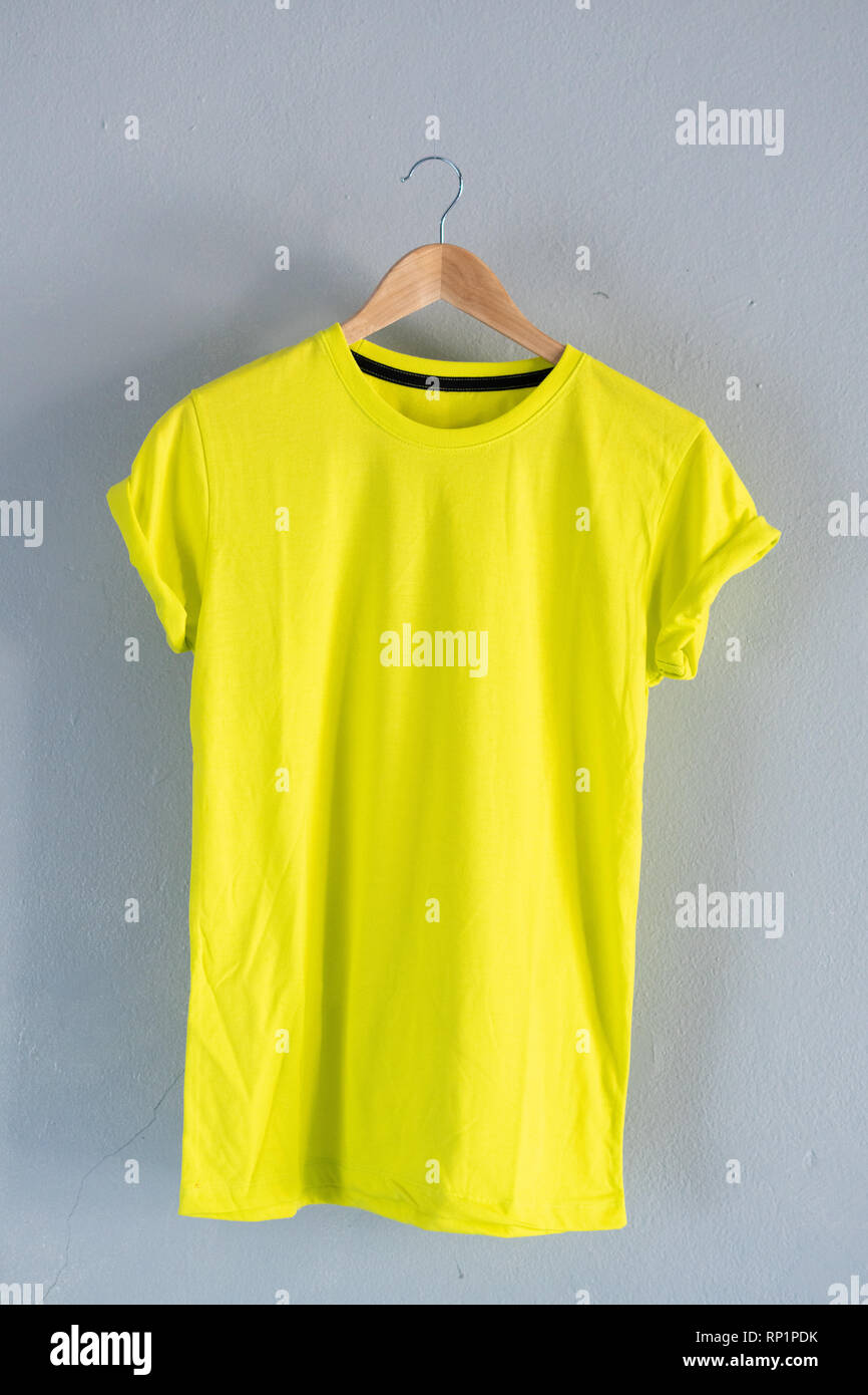 Retro fold Lemon cotton T-Shirt clothes colorful mock up template on grunge white wood background concept for retail dress shop backdrop, Blank flat Stock Photo
