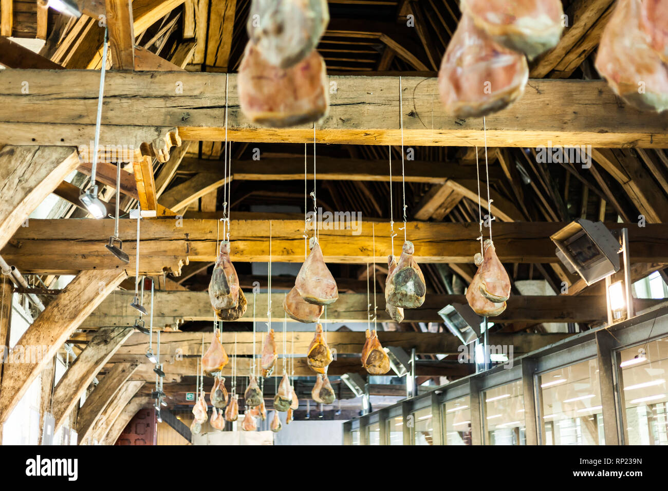 Hooked Ham On Wooden Beams That Hang From The Ceiling Traditional