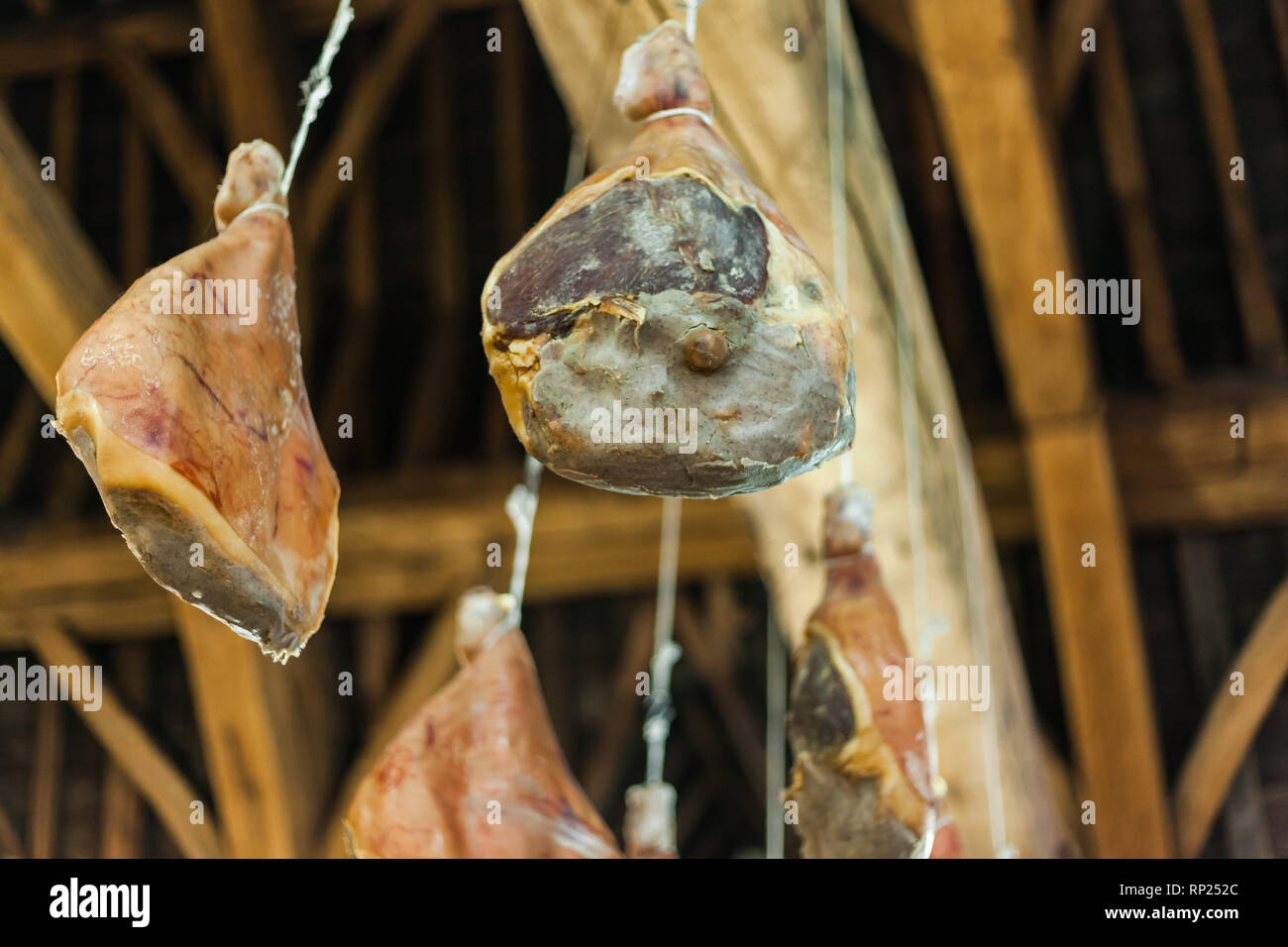 Hooked Ham On Wooden Beams That Hang From The Ceiling Traditional