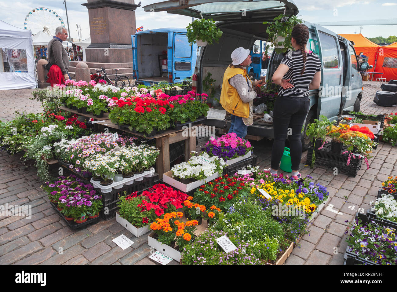 Helsinki, Finland - May 21, 2016: Flower shop with ordinary people on the street of Helsinki Stock Photo