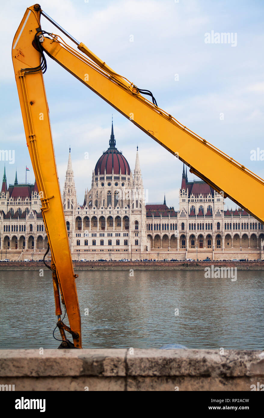 Parlament building in Budapest framed with yellow grabber arms on river Danube. Stock Photo