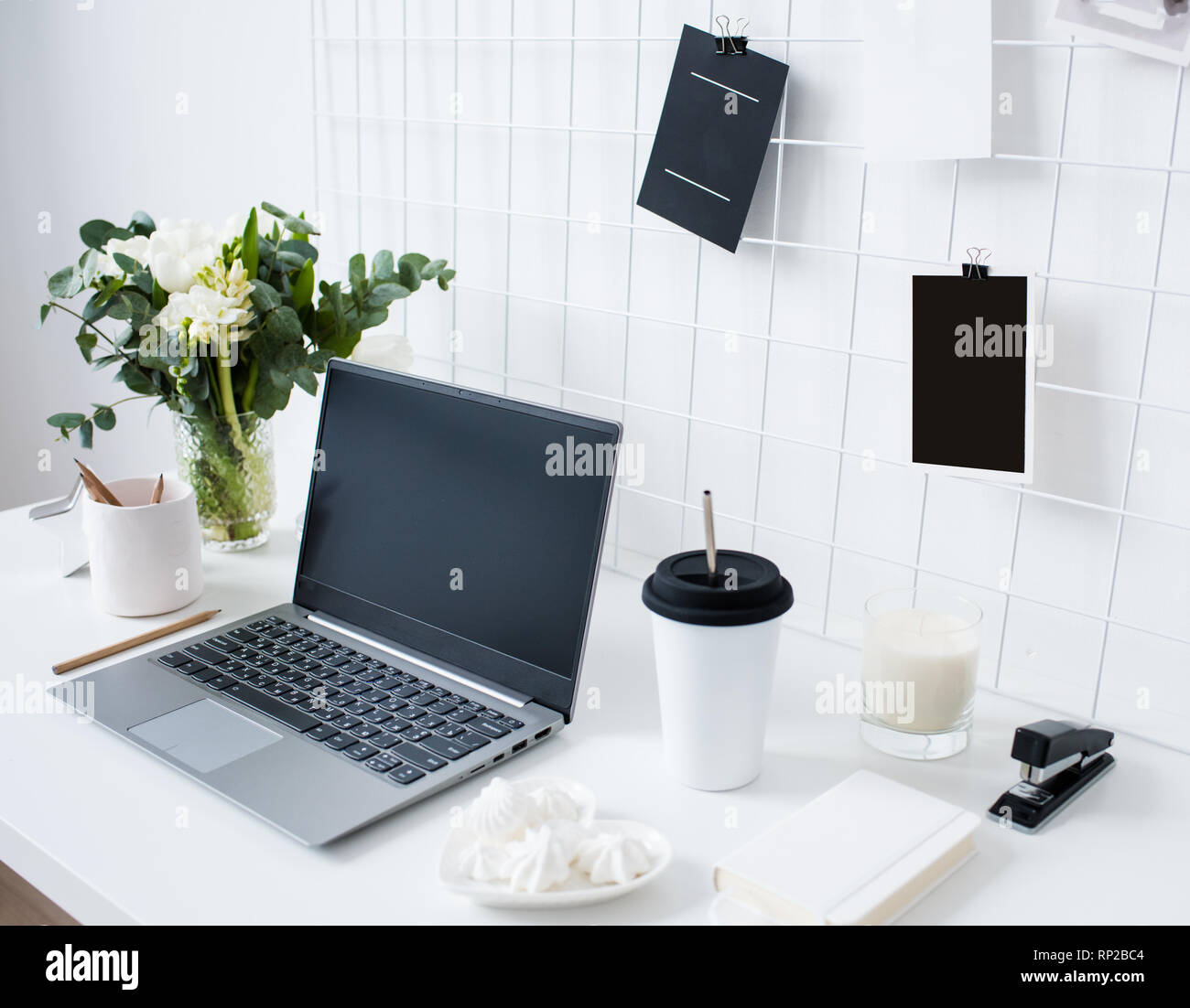 Stylish white professional office interior, minimalist loft workspace with  table, laptop and moodboard Stock Photo - Alamy