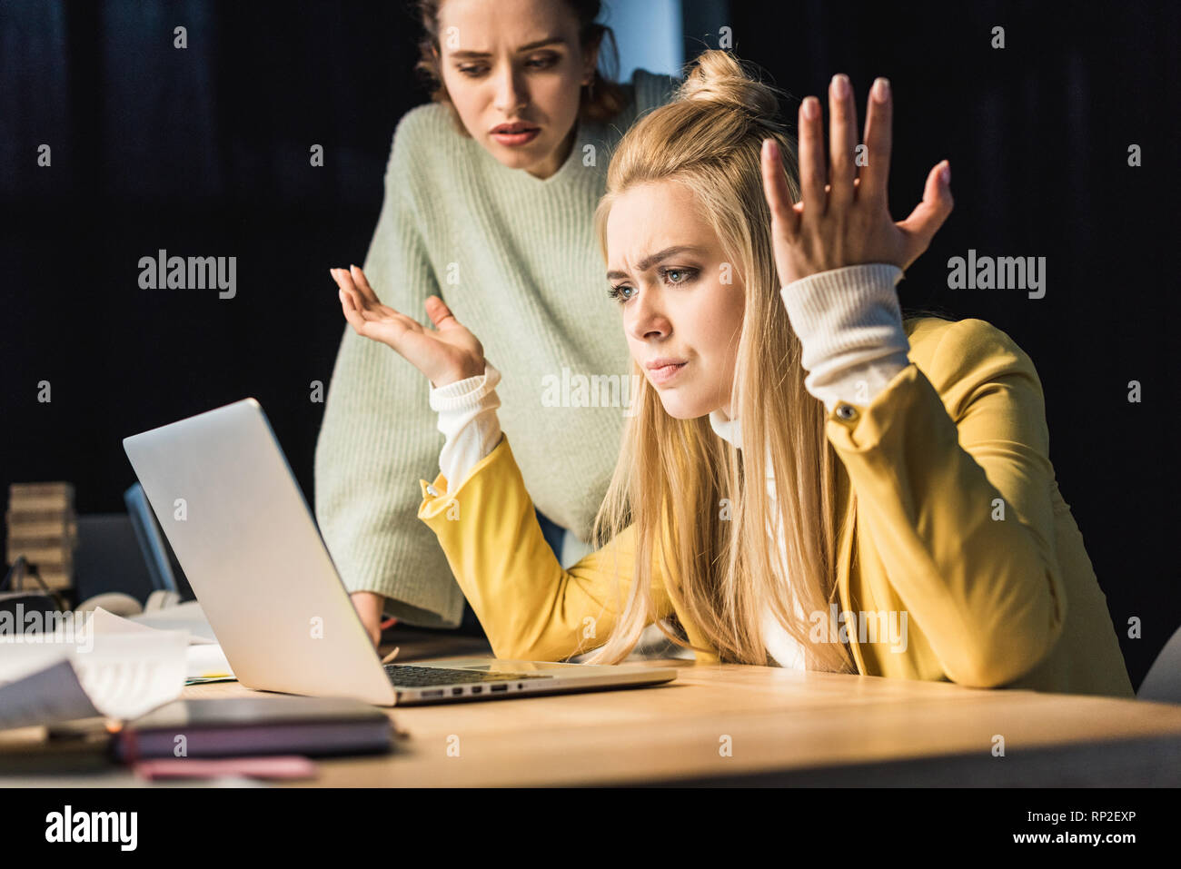 beautiful confused female it specialists using laptop in office Stock Photo