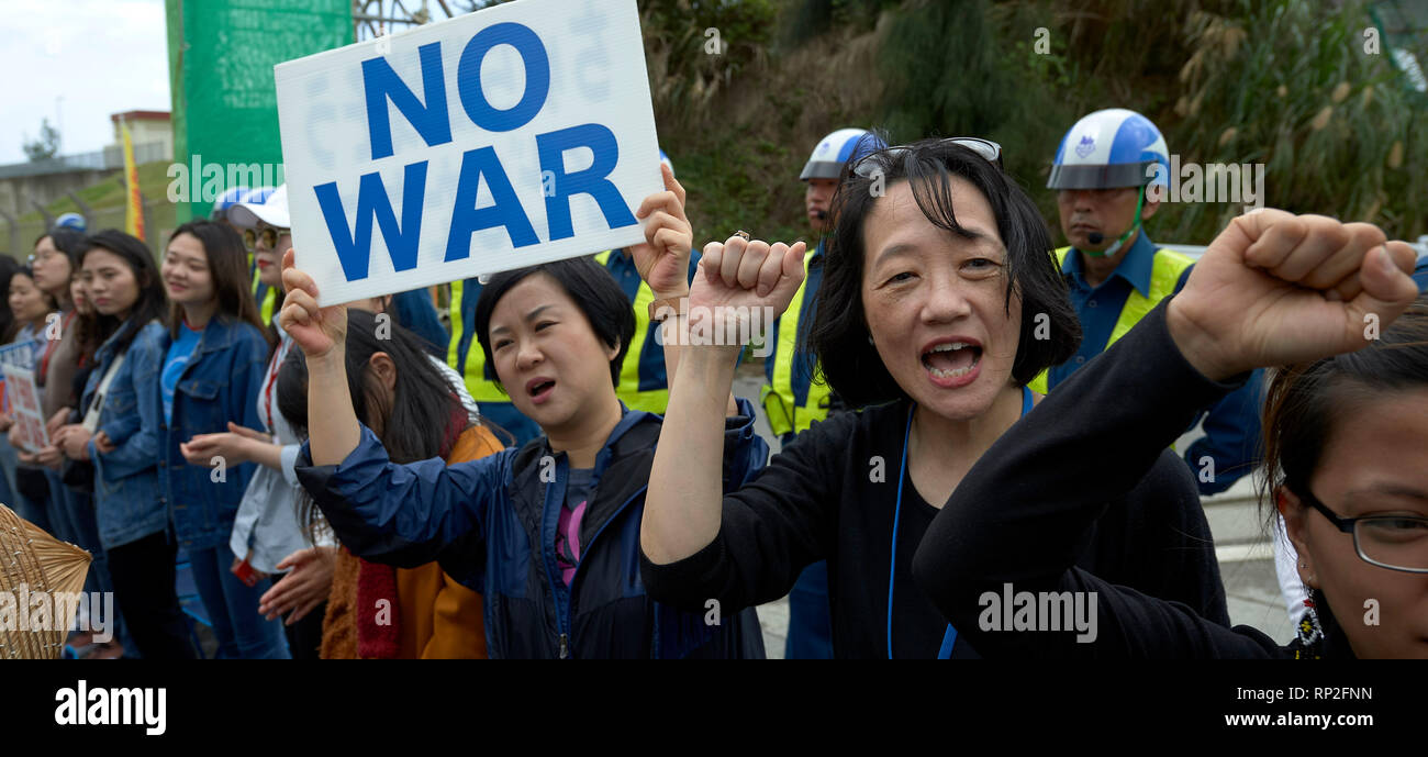 Henoko, Okinawa, Japan. 19th Feb, 2019. protesters block a gate of a new U.S. Marine Corps airbase being constructed at Henoko on the Japanese island of Okinawa. Dozens of protesters, who want the construction halted, had to be physically removed in order for trucks of fill to enter the base, which is filling in a huge section of sea in order to build a new airfield. Credit: Paul Jeffrey/Alamy Live News Stock Photo