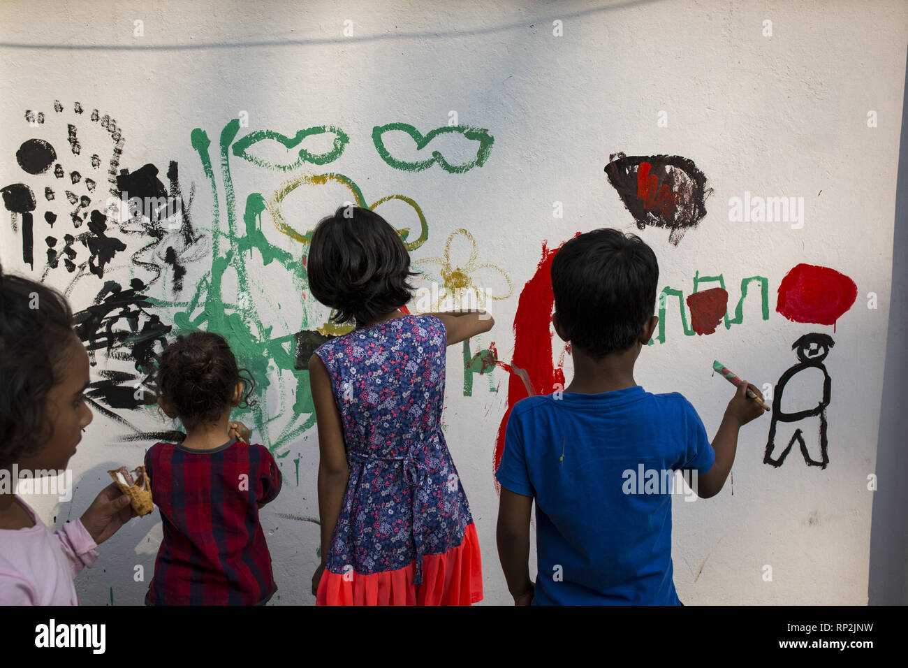 February 20, 2019 - DHAKA, BANGLADESH - FEBRUARY 20 : Children paints on the wall as part of the decoration for the International Mother Language Day celebration in front of the language matyrs monument  in Dhaka, Bangladesh on February 20, 2019...The nation will pay tribute to the Bangla language movement martyrs who sacrificed their life for their mother tongue in 1952, while the United Nations Educational Scientific and Cultural Organization (UNESCO) declared 21 February as the International Mother Language Day. (Credit Image: © Zakir Hossain Chowdhury/ZUMA Wire) Stock Photo