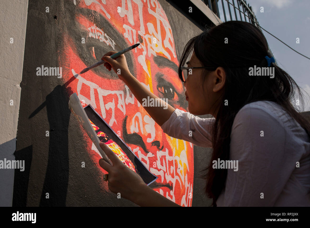 Dhaka, Bangladesh. 20th Feb, 2019.  An artist paints on the wall as part of the decoration for the International Mother Language Day celebration in front of the language matyrs monument  in Dhaka, Bangladesh on February 20, 2019.  The nation will pay tribute to the Bangla language movement martyrs who sacrificed their life for their mother tongue in 1952, while the United Nations Educational Scientific and Cultural Organization (UNESCO) declared 21 February as the International Mother Language Day. Credit: zakir hossain chowdhury zakir/Alamy Live News Stock Photo