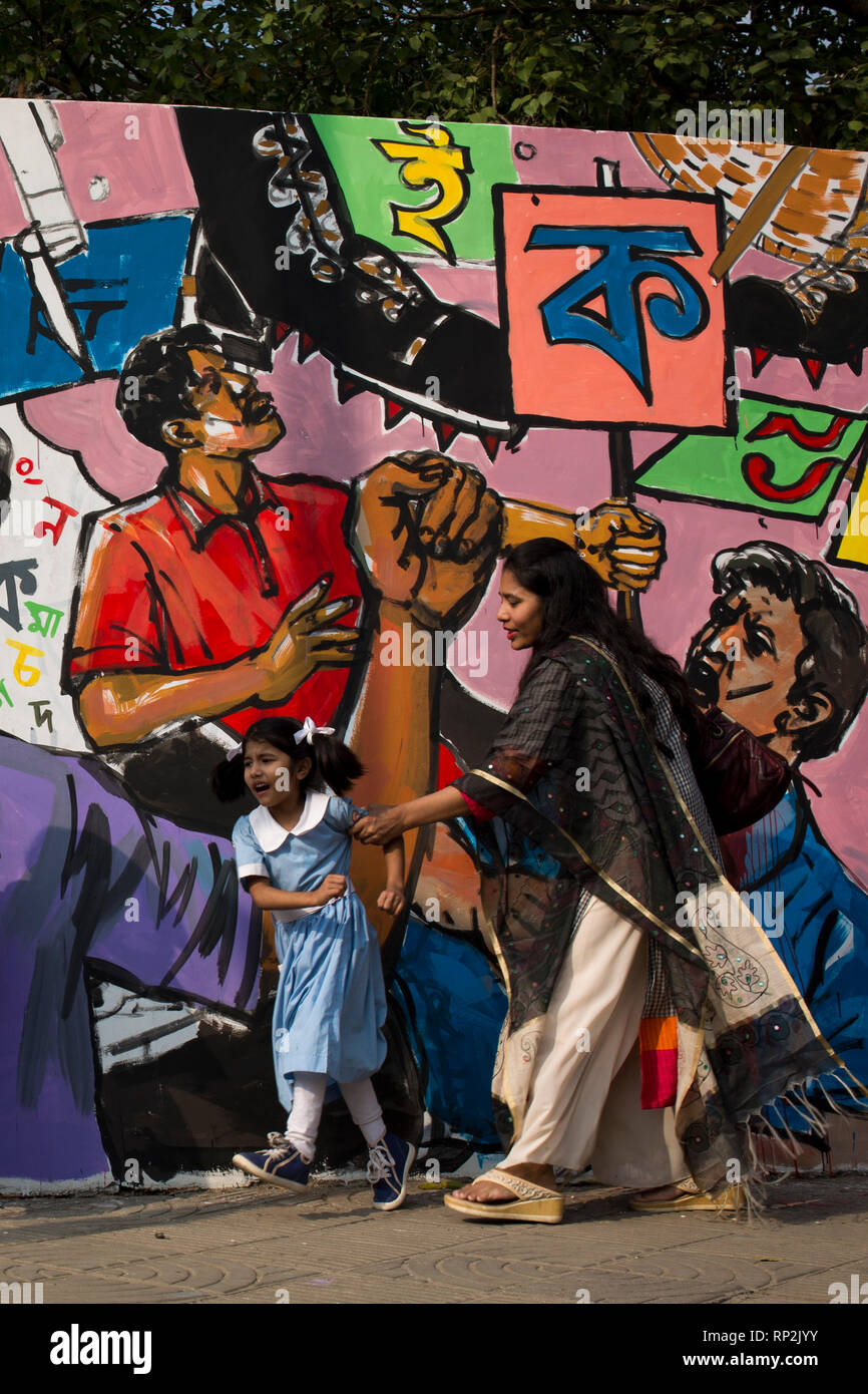 Dhaka, Bangladesh. 20th Feb, 2019.  School student walks beside wall that paints as part of the decoration for the International Mother Language Day celebration in front of the language matyrs monument  in Dhaka, Bangladesh on February 20, 2019.  The nation will pay tribute to the Bangla language movement martyrs who sacrificed their life for their mother tongue in 1952, while the United Nations Educational Scientific and Cultural Organization (UNESCO) declared 21 February as the International Mother Language Day. Credit: zakir hossain chowdhury zakir/Alamy Liv Stock Photo