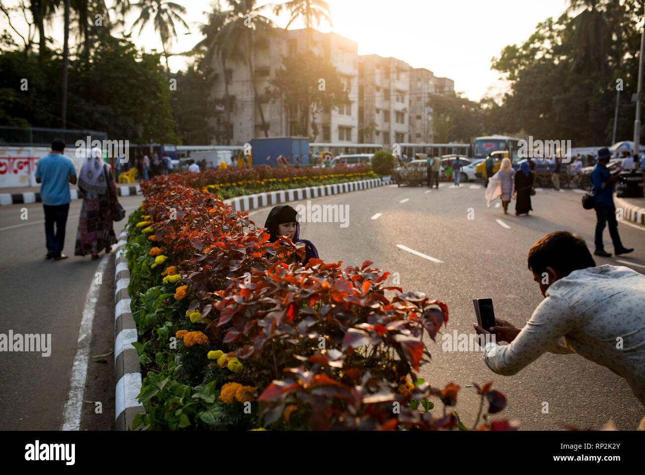 Dhaka, Bangladesh. 20th Feb, 2019.  A boy taking pictures of a girl using mobile in front of the language matyrs monument  in Dhaka, Bangladesh on February 20, 2019.  The nation will pay tribute to the Bangla language movement martyrs who sacrificed their life for their mother tongue in 1952, while the United Nations Educational Scientific and Cultural Organization (UNESCO) declared 21 February as the International Mother Language Day. Credit: zakir hossain chowdhury zakir/Alamy Live News Stock Photo