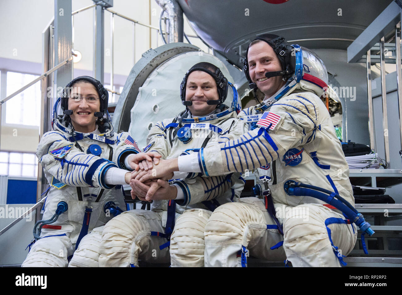 Star City, Russia. 20th Feb, 2019. International Space Station Expedition 59 crew members pose together for the media on their Soyuz spacecraft simulator February 20, 2019 at Star City, Russia. Left to right are: Christina Koch of NASA, Alexey Ovchinin of Roscosmos, and Nick Hague of NASA. They crew will launch March 14th from the Baikonur Cosmodrome in Kazakhstan on the Soyuz MS-12 spacecraft for a six-and-a-half month mission on the International Space Station. Credit: Planetpix/Alamy Live News Stock Photo
