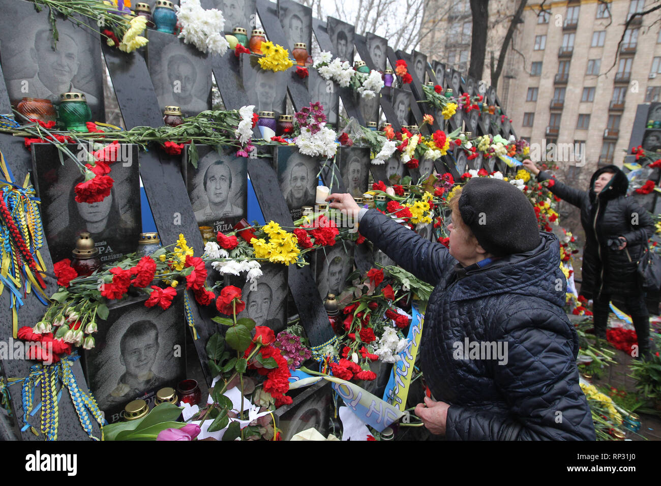 Ukrainians are seen placing flowers and lighting candles at the memorial of the Maidan activists who were killed during the 5th anniversary. Euromaidan Revolution or Revolution of Dignity was a wave of demonstrations and civil unrest in Ukraine, which began on the night of 21 November 2013 with public protests at the Independence Square in Kiev, demanding European integration. The protests led to the 2014 Ukrainian revolution and the ouster of President Viktor Yanukovych. Stock Photo