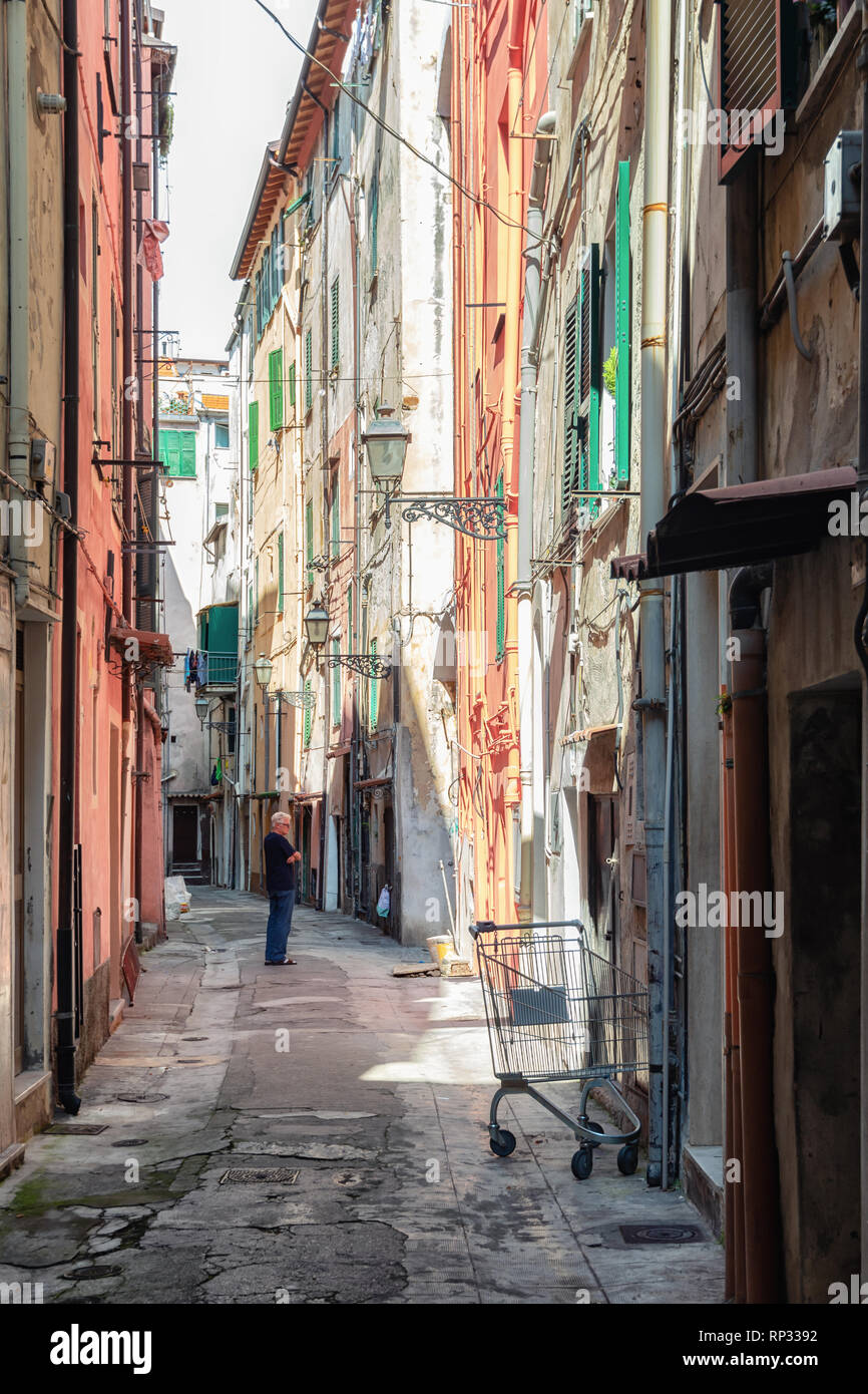 San Remo, Italy, September 18, 2018:  Man is pondering in the narrow street Via Bezzecca in the center of the Italian town San Remo Stock Photo