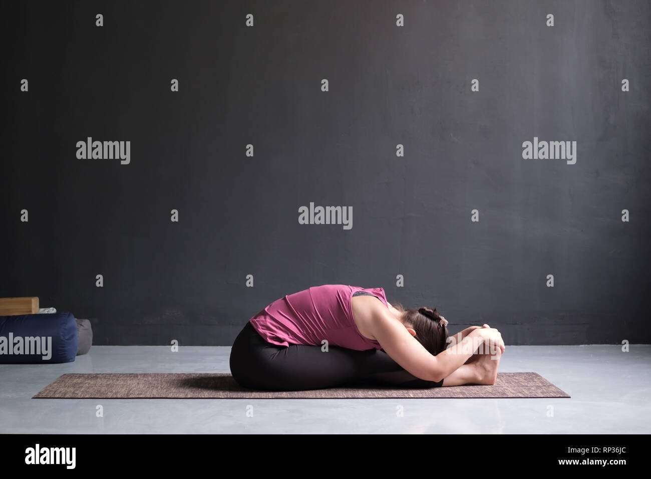 woman practicing yoga, Seated forward bend pose Stock Photo - Alamy