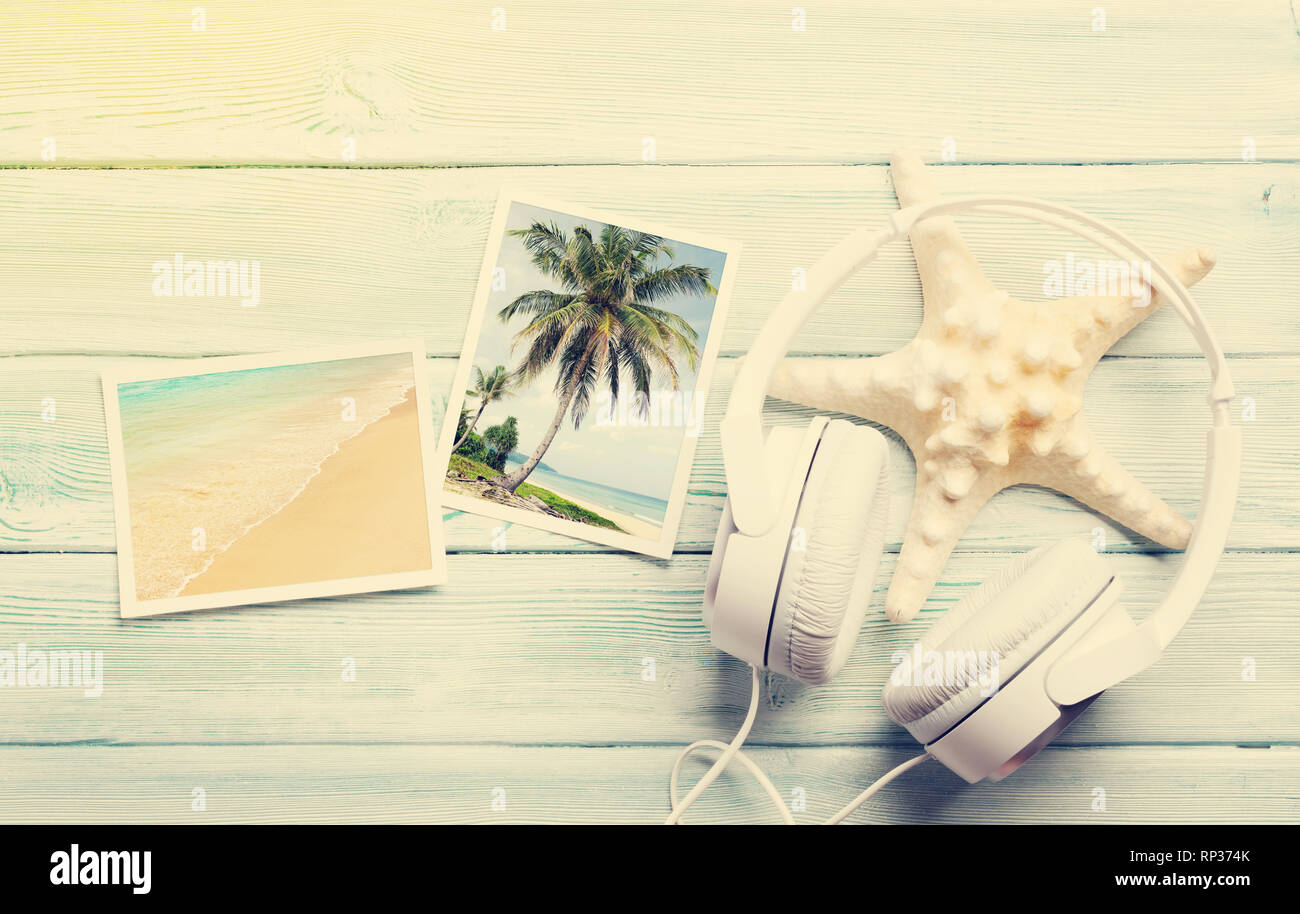 Travel vacation and music concept with headphones, starfish and photos on wooden backdrop. Top view with copy space. Flat lay. All photos taken by me. Stock Photo