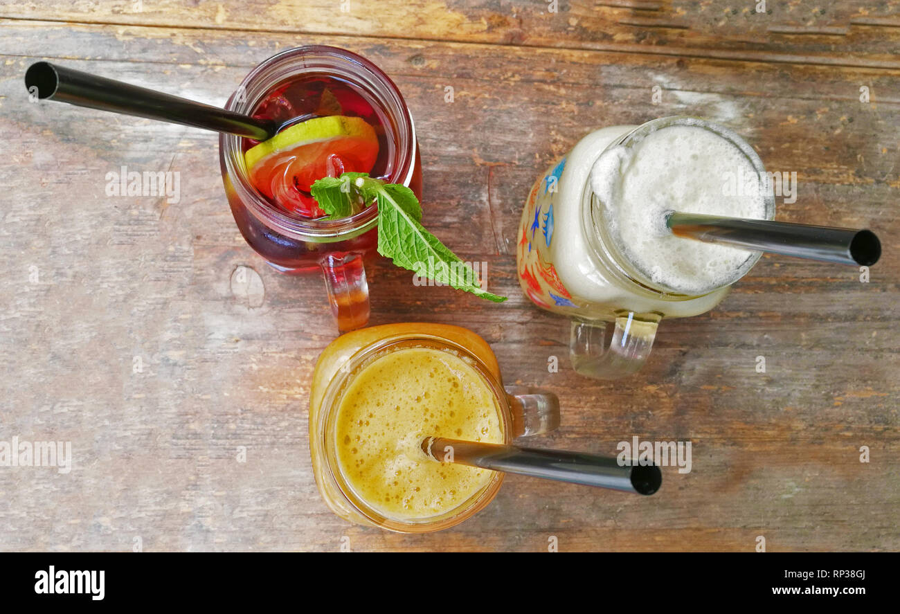 Tipical cocktails from india of different fruits on wood table Stock