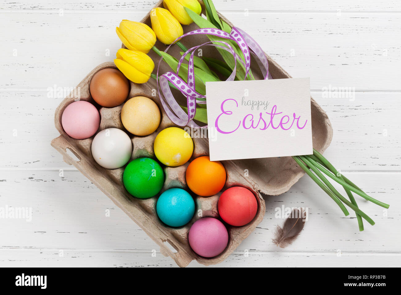 Easter greeting card with colorful easter eggs on wooden table. Top ...