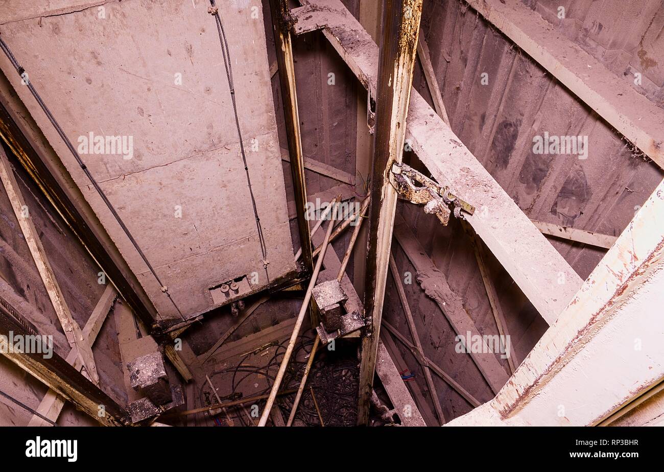 Old lift shaft with counterweight. Elevator reconstruction. Industrial object. Close-up. Stock Photo