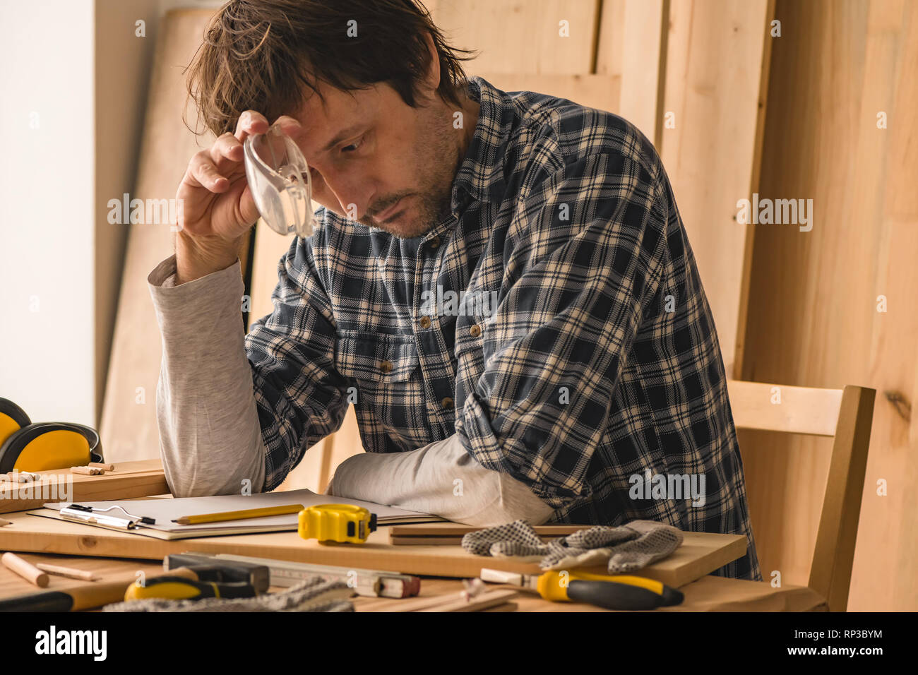 Carpenter planning DIY project in his small business woodwork workshop Stock Photo
