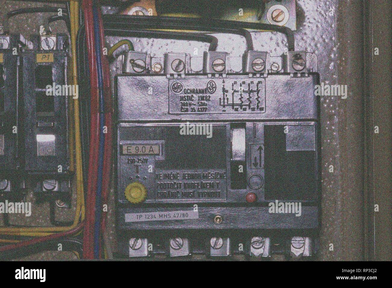 Old 3 phase circuit breaker in electric distribution case. Closeup. Add