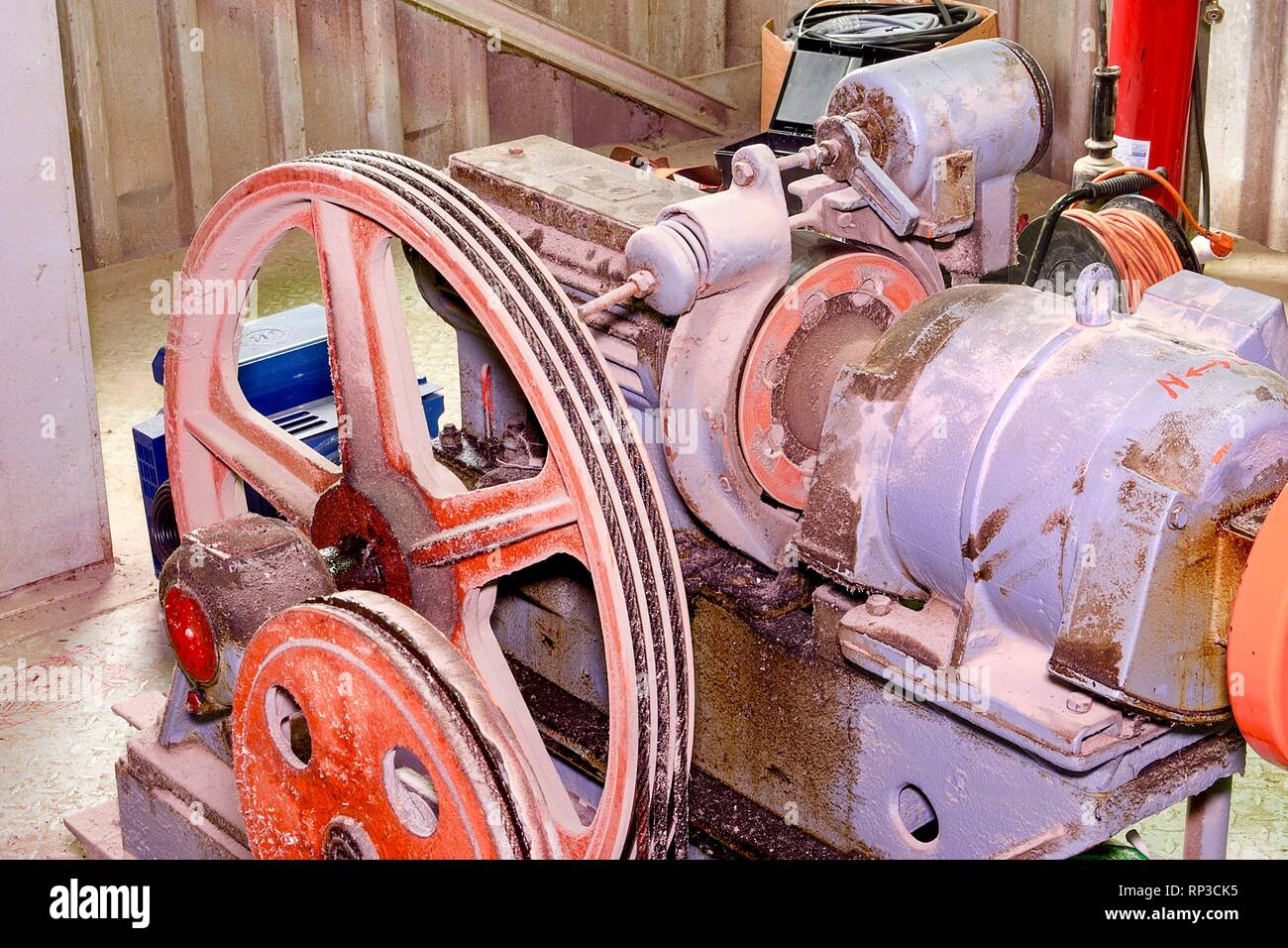Part of industrial lift. Pulley wheel and engine in engine room