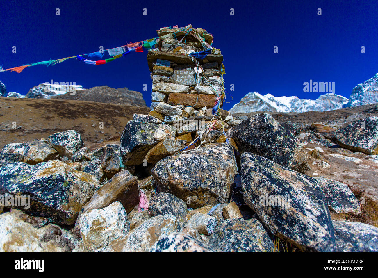 Prayer flags lead off a shrine on the trek towards Mt. Everest, Nepal Stock Photo