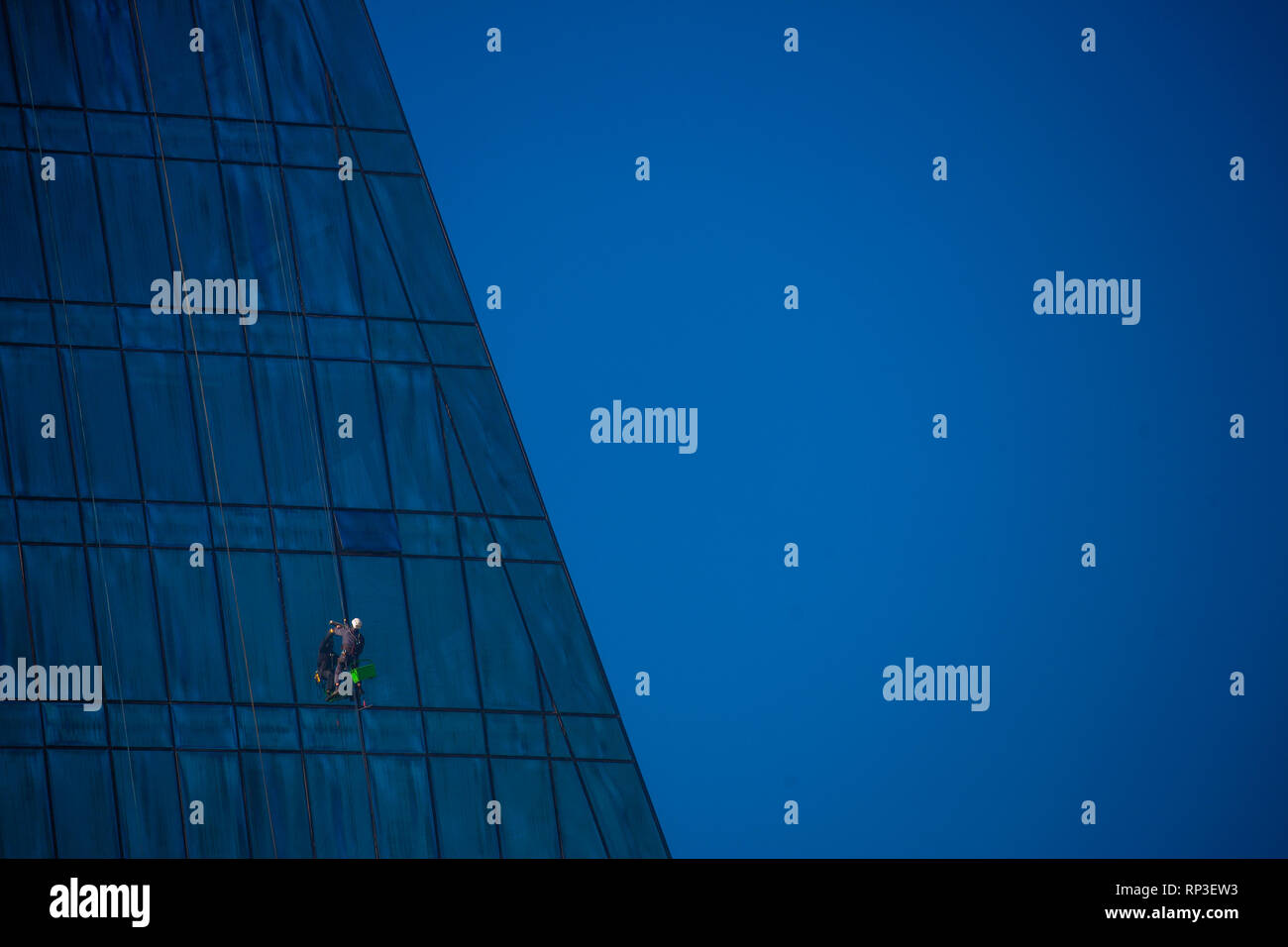 A closeup of a window cleaner on Baku's Flame Tower. Stock Photo