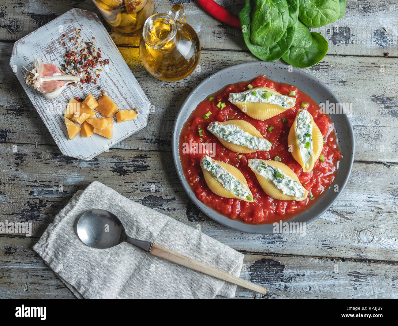 pasta conchiglioni stuffed spinach and cheese, tomato sauce on plate ,cooked Stock Photo