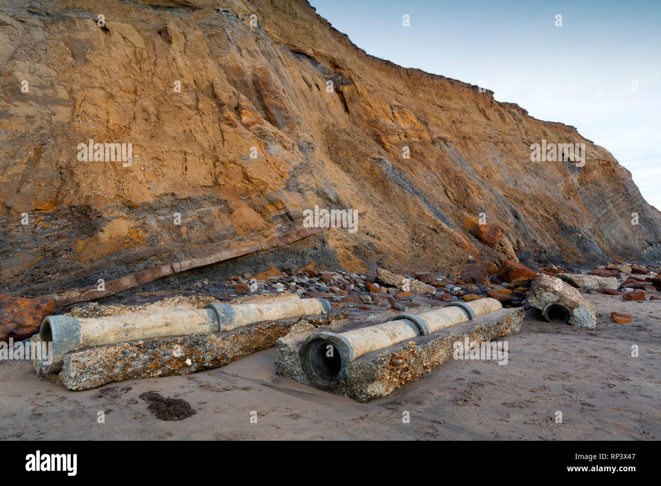 Coastal, Erosion, debris, on the, beach, pipes, cracks, cliffs, lower, greensand, wealden, beds, geology, Compton, Bay, Isle of Wight, UK, Stock Photo