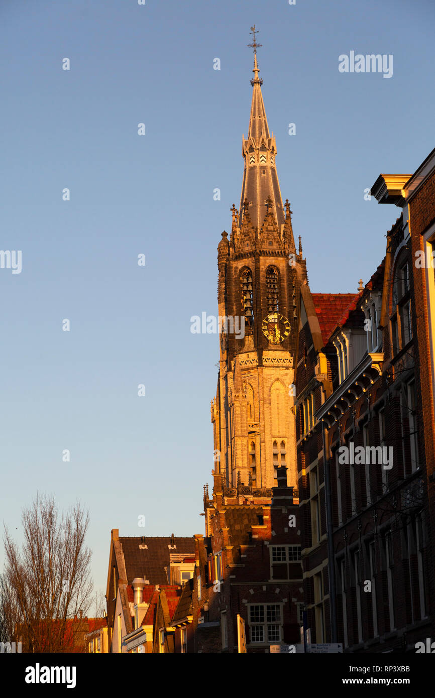 The spire of the Nieuwe Kerk (New Church) in Delft, the Netherlands. The tower stands more than 108 metres tall and peeks over Dutch Golden Age buildi Stock Photo