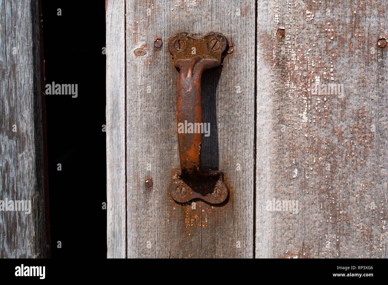 Rusted handles on old barn door. Stock Photo