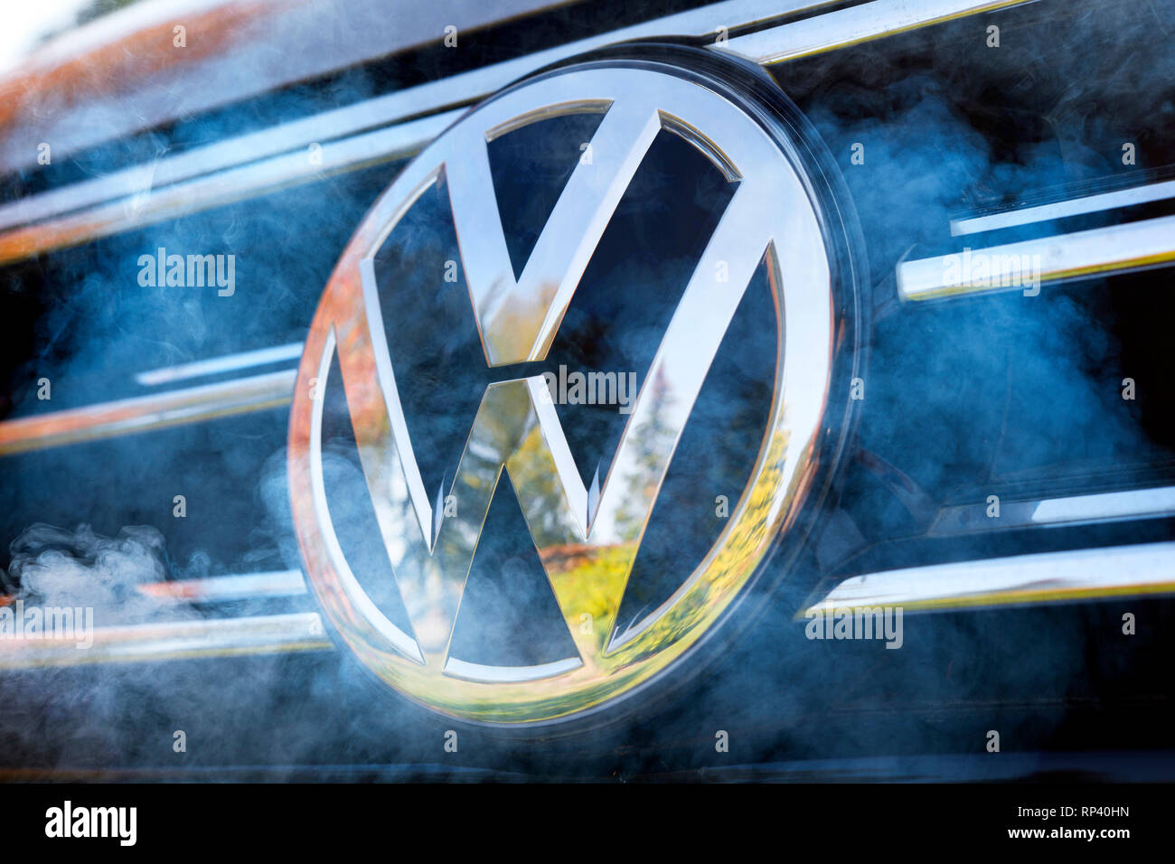 VW signs on a car and exhaust gas, diesel scandal, VW-Zeichen auf einem Auto und Autoabgase, Dieselskandal Stock Photo
