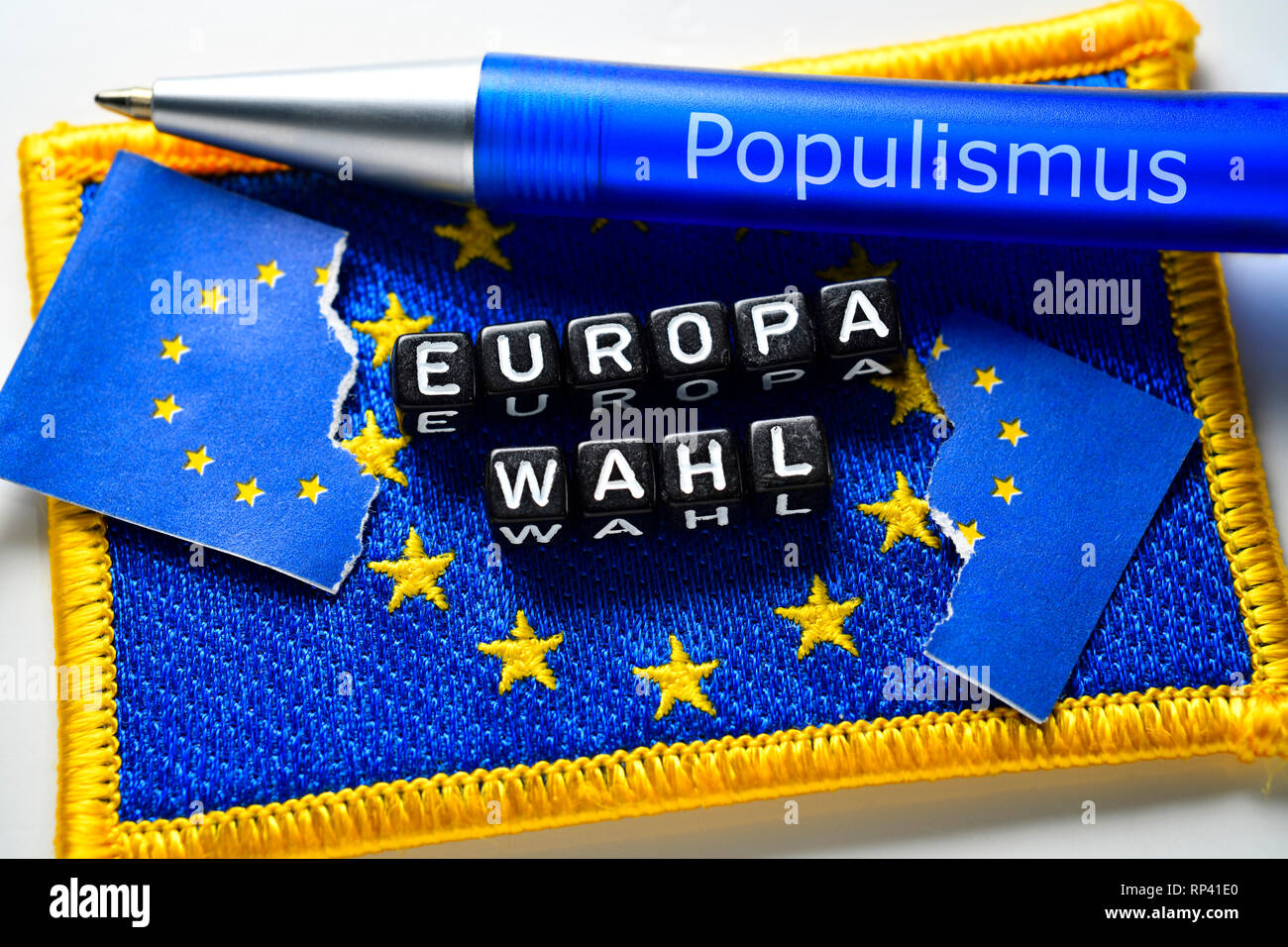 Stroke European choice with torn EU flag and ballpoint pen with label Populism, Schriftzug Europawahl mit zerrissener EU-Fahne und Kugelschreiber mit  Stock Photo